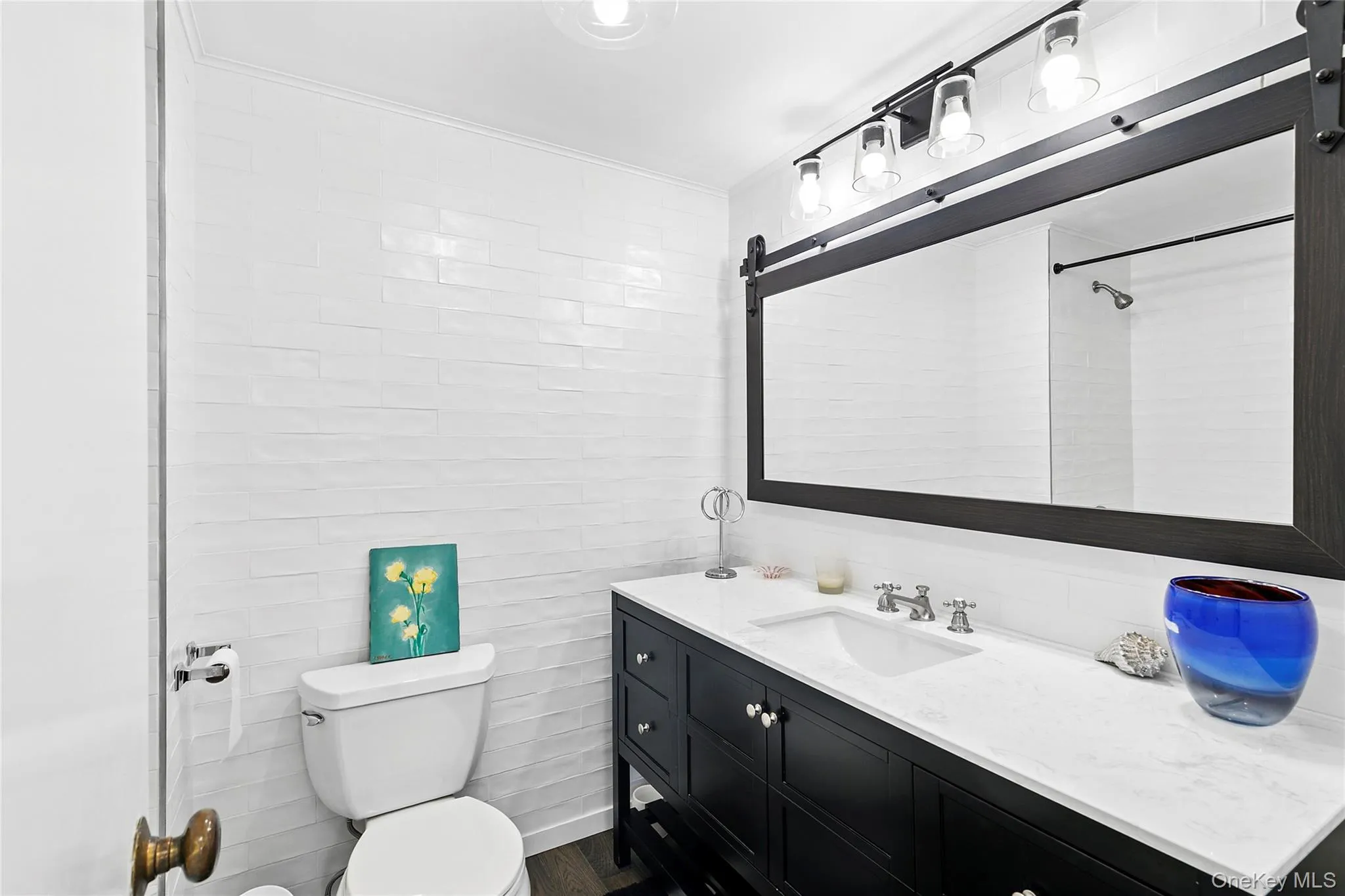 Full bath featuring vanity and tile walls Full bath featuring vanity and tile walls