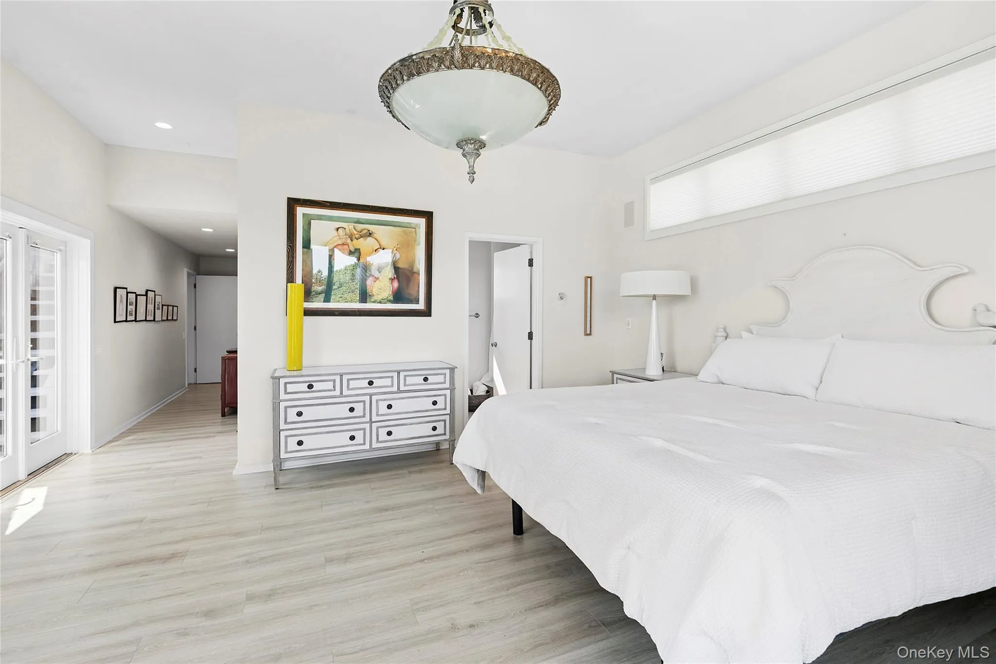 Bedroom with light wood-style flooring, access to outside, and recessed lighting Bedroom with light wood-style flooring, access to outside, and recessed lighting