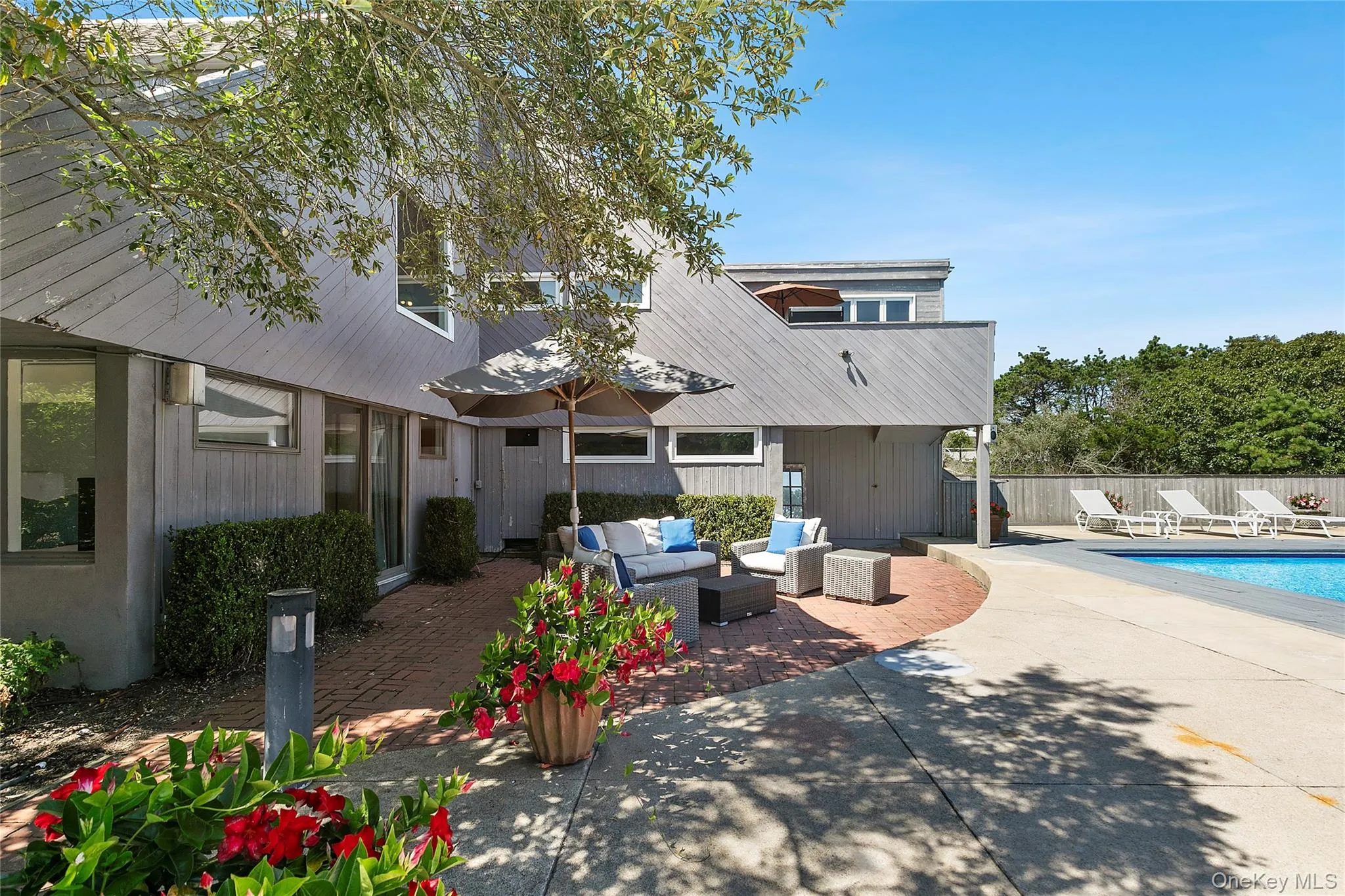 Rear view of house with an outdoor hangout area, a patio area, and a metal roof Rear view of house with an outdoor hangout area, a patio area, and a metal roof
