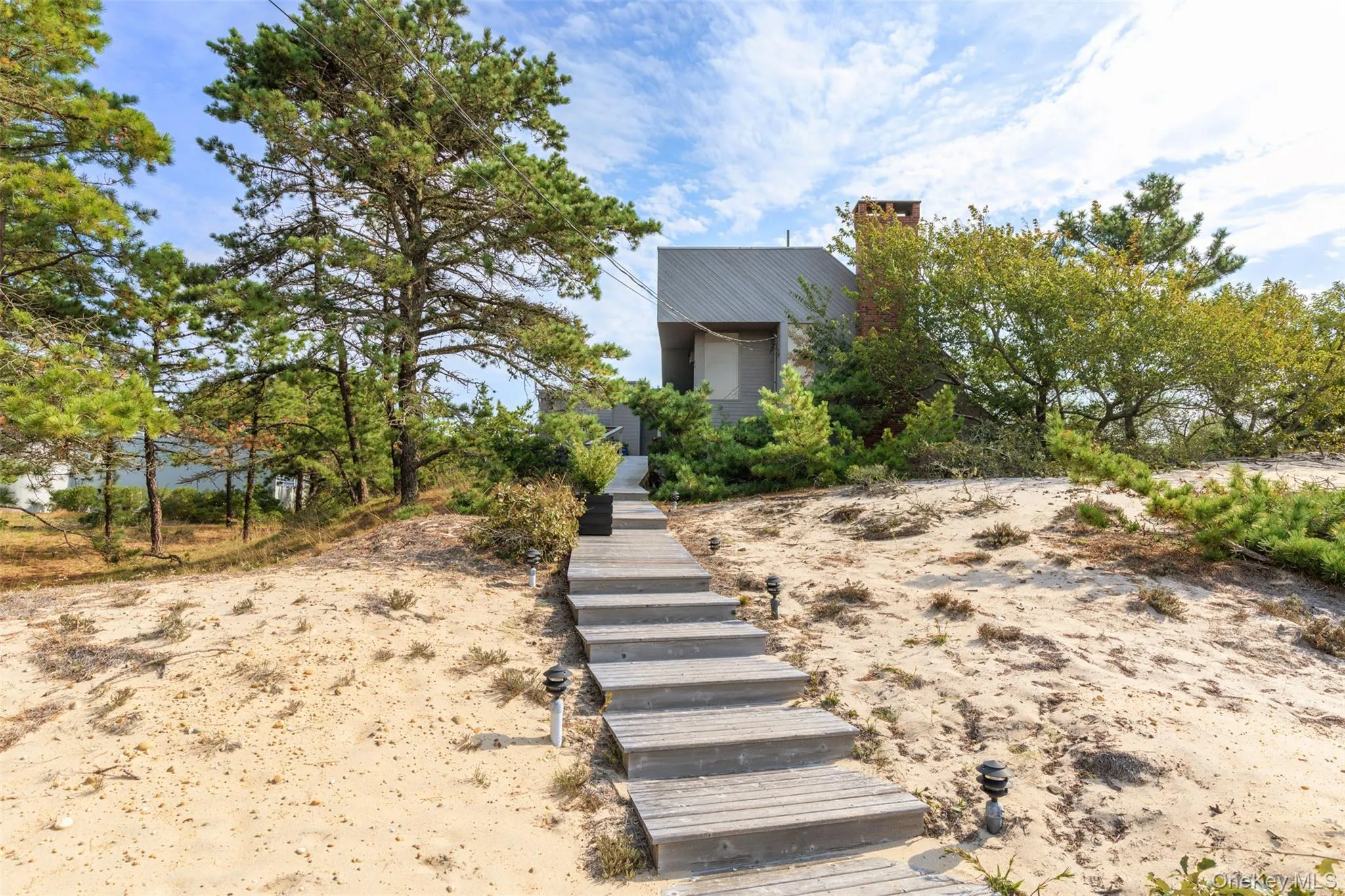 View of front of property with a chimney and stairway View of front of property with a chimney and stairway