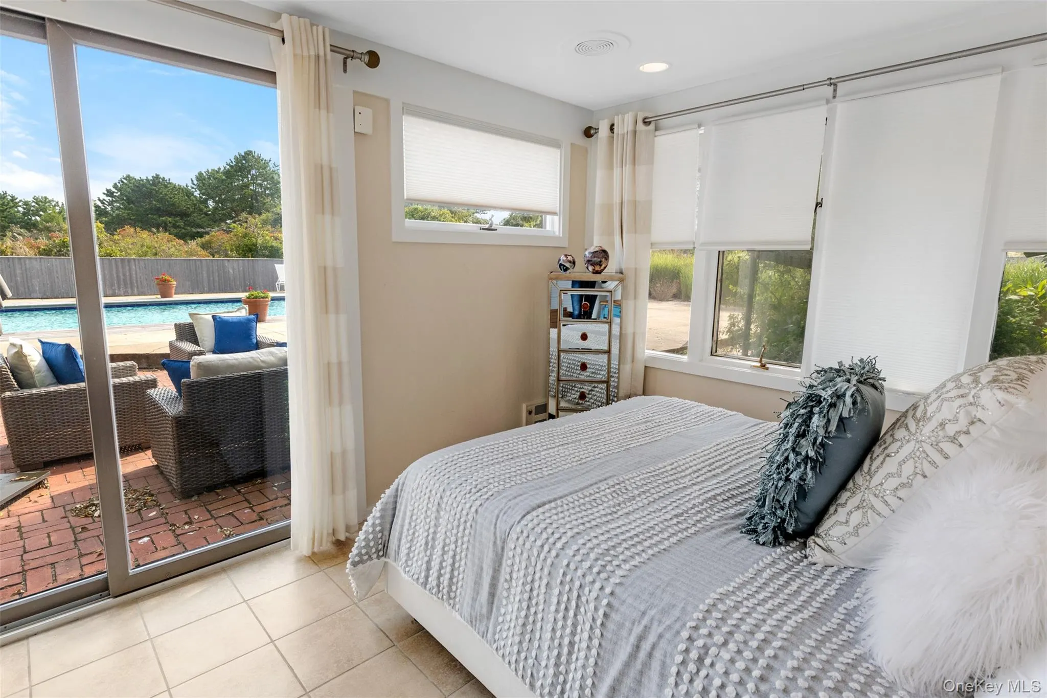 Tiled bedroom with multiple windows Tiled bedroom with multiple windows