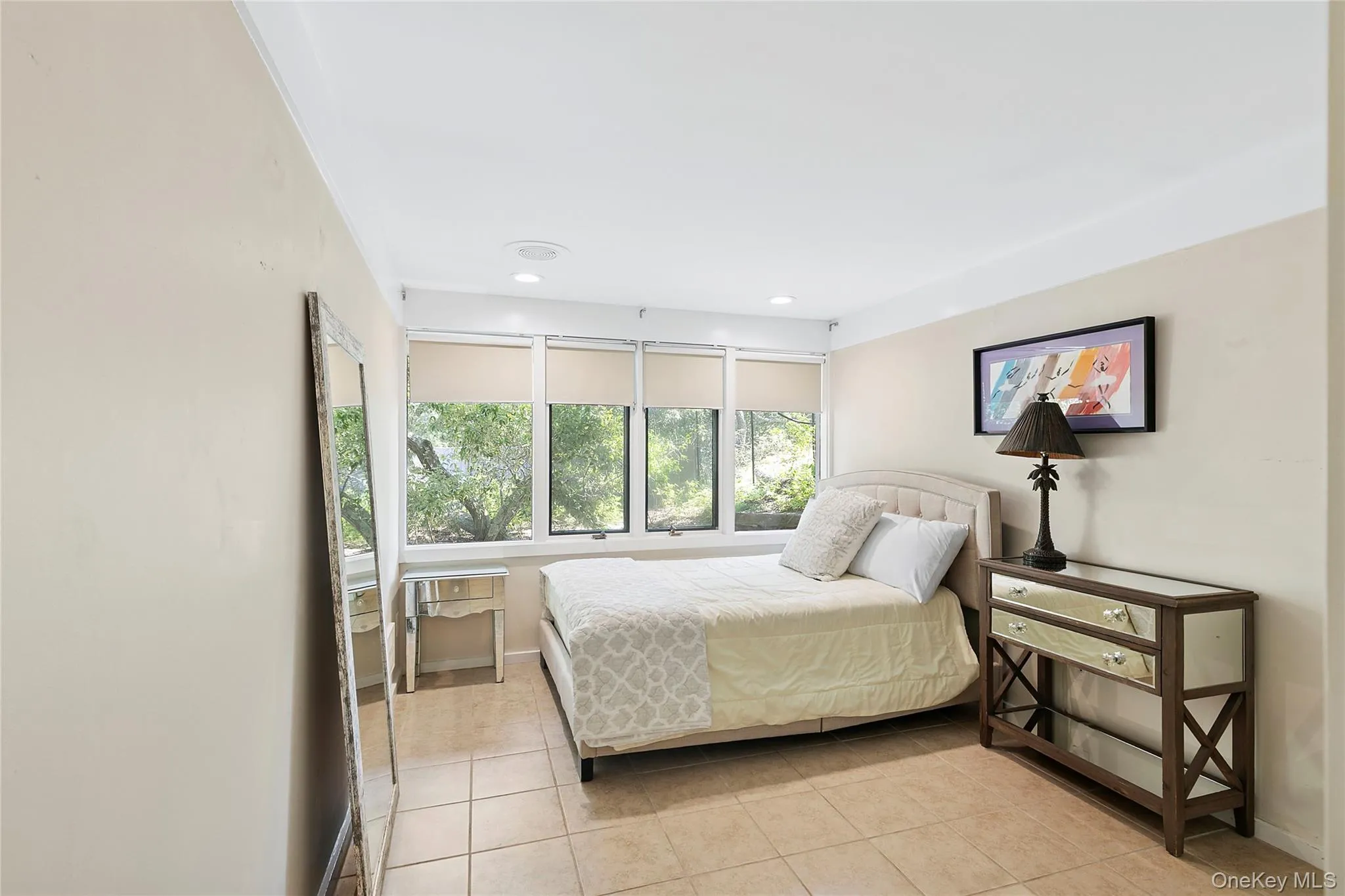Bedroom with light tile patterned floors and recessed lighting Bedroom with light tile patterned floors and recessed lighting