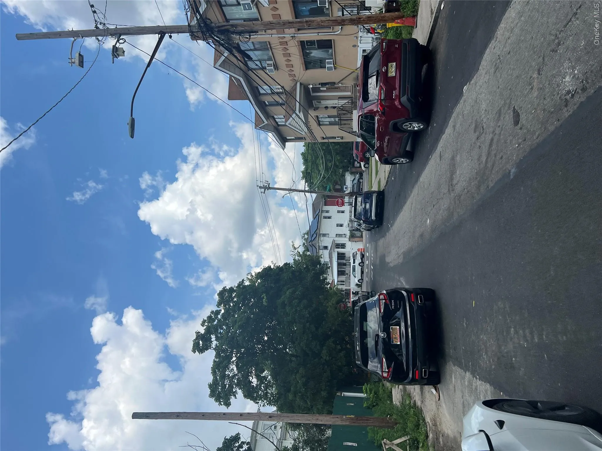 View of asphalt road with street lights, a residential view, and sidewalks View of asphalt road with street lights, a residential view, and sidewalks