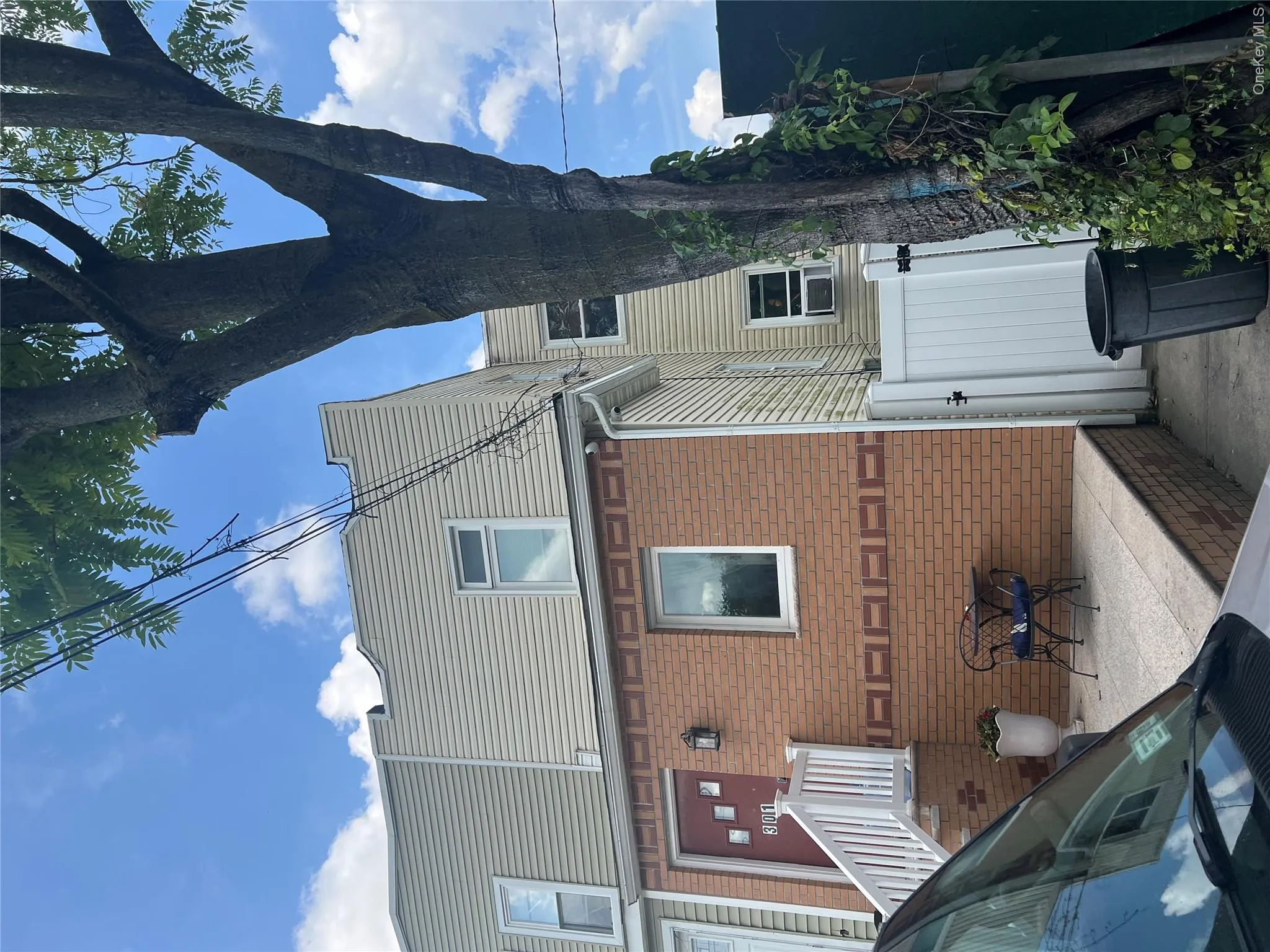 Rear view of property with a gate and brick siding Rear view of property with a gate and brick siding