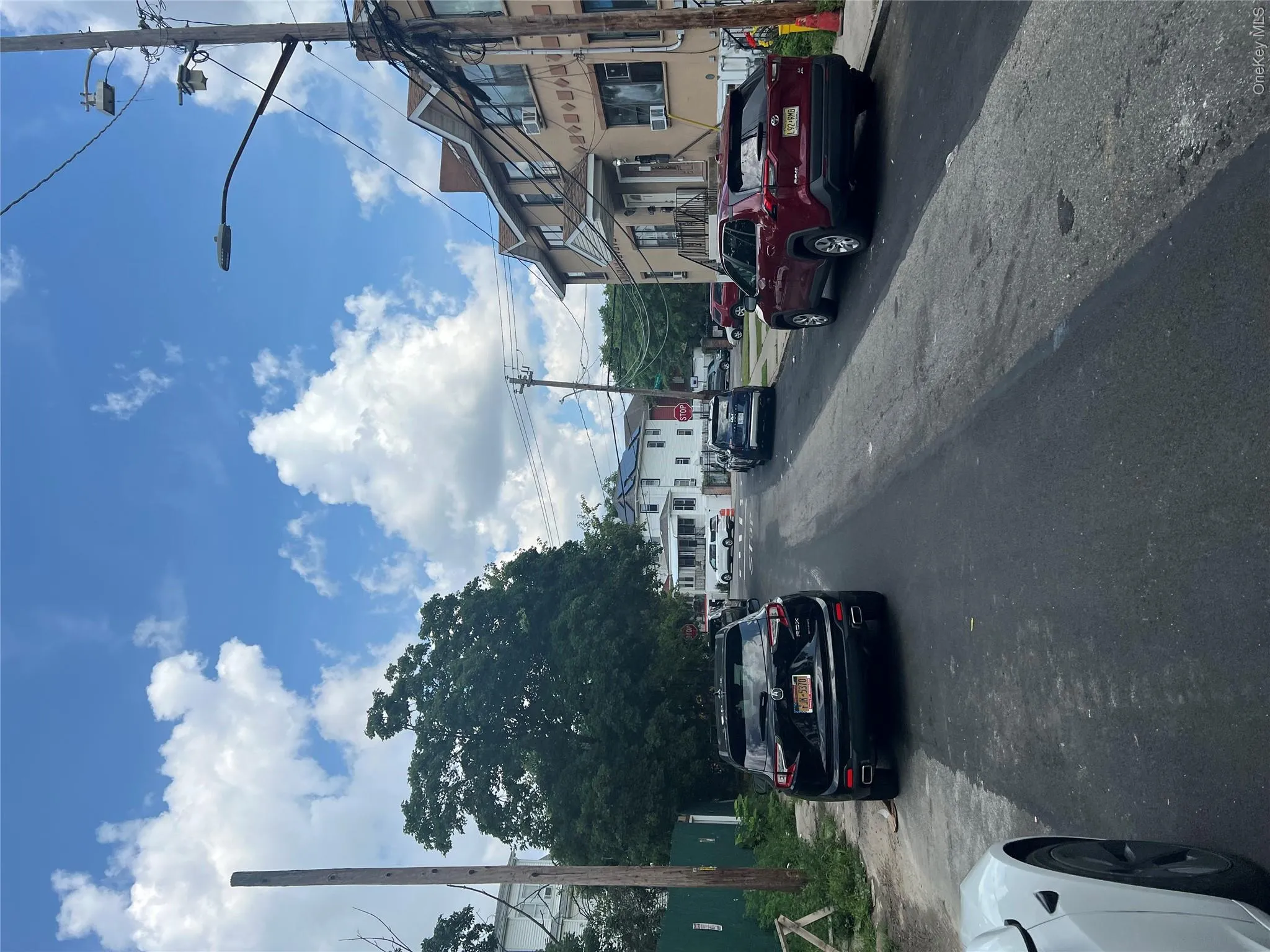 View of asphalt street with street lights and sidewalks View of asphalt street with street lights and sidewalks