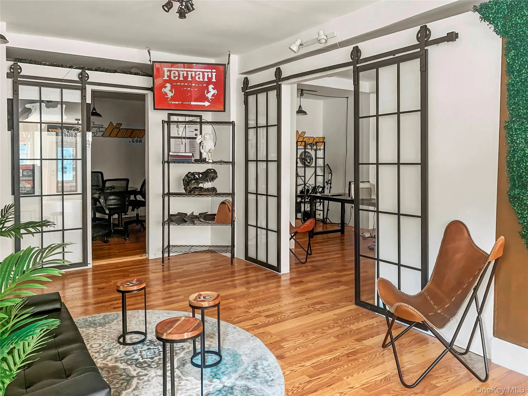 Sitting room featuring a desk, wood finished floors, a barn door, and french doors Sitting room featuring a desk, wood finished floors, a barn door, and french doors