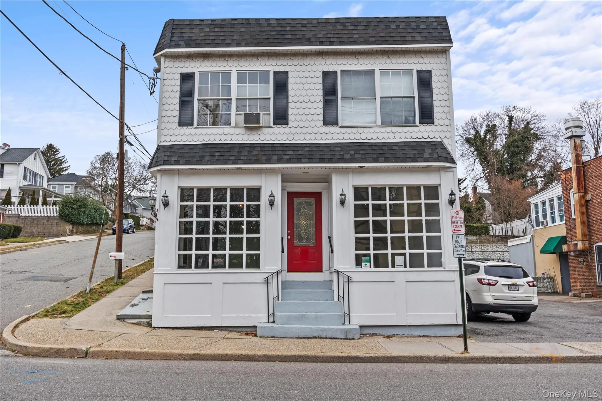 Traditional-style house featuring a shingled roof and entry steps Traditional-style house featuring a shingled roof and entry steps