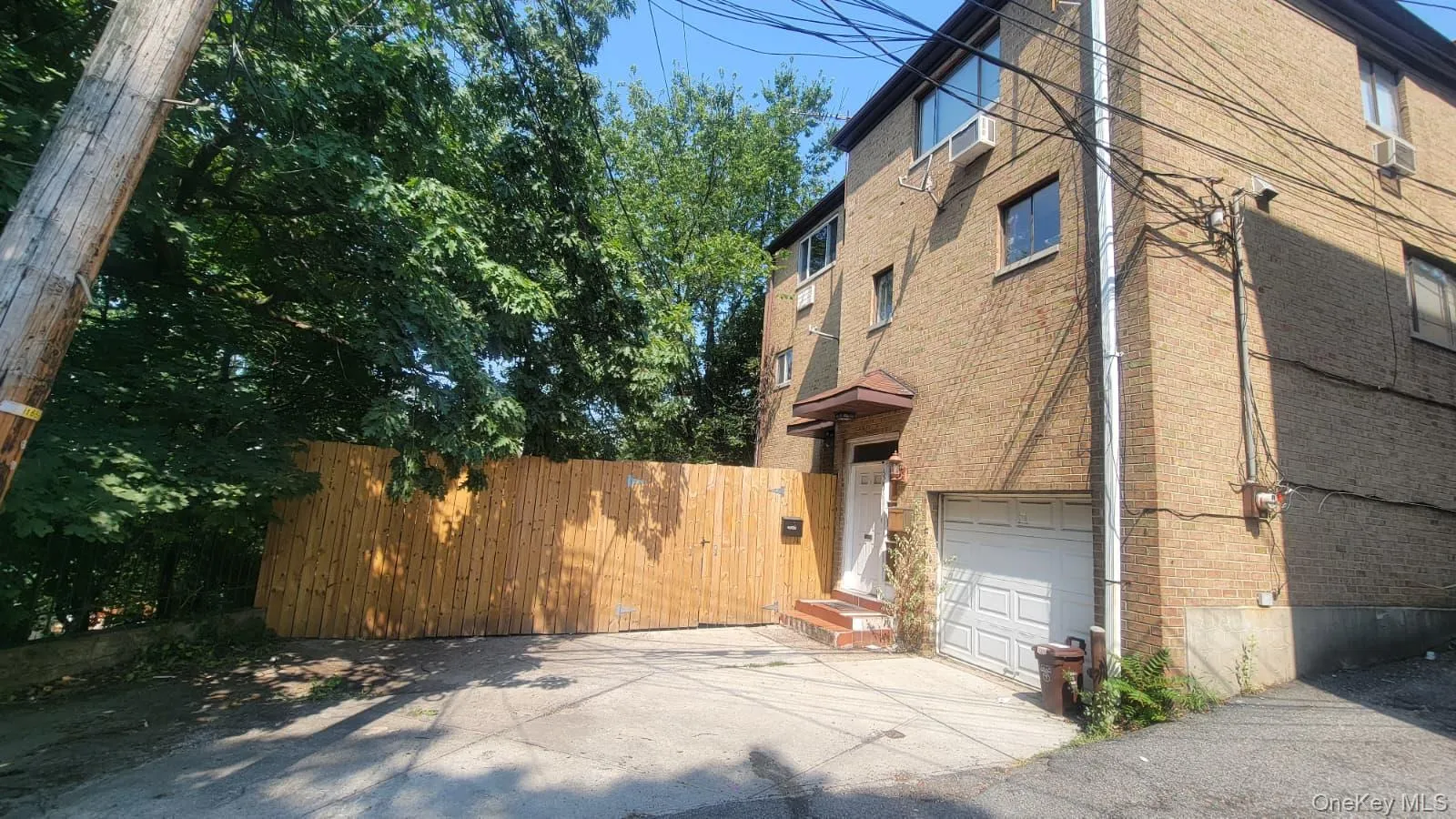 View of home's exterior featuring an attached garage, driveway, and brick siding View of home's exterior featuring an attached garage, driveway, and brick siding