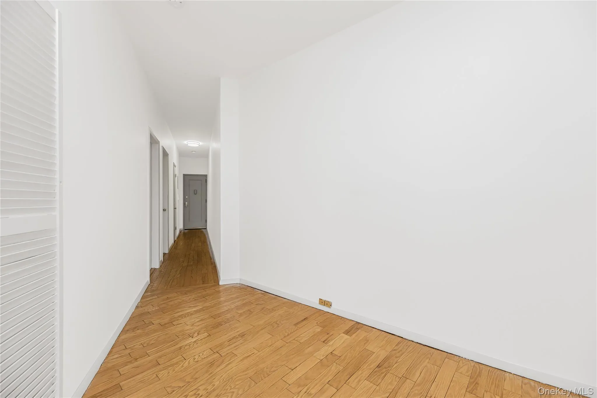 Hall with light wood-style floors and baseboards Hall with light wood-style floors and baseboards