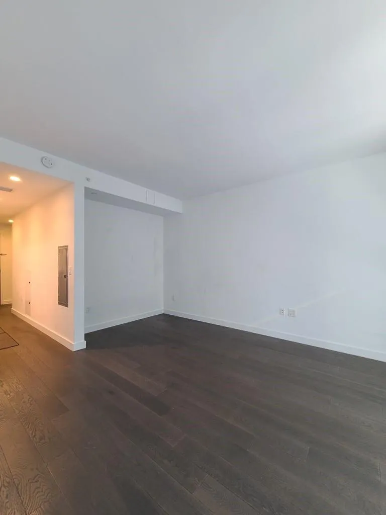 Unfurnished living room with dark wood-style floors and recessed lighting Unfurnished living room with dark wood-style floors and recessed lighting