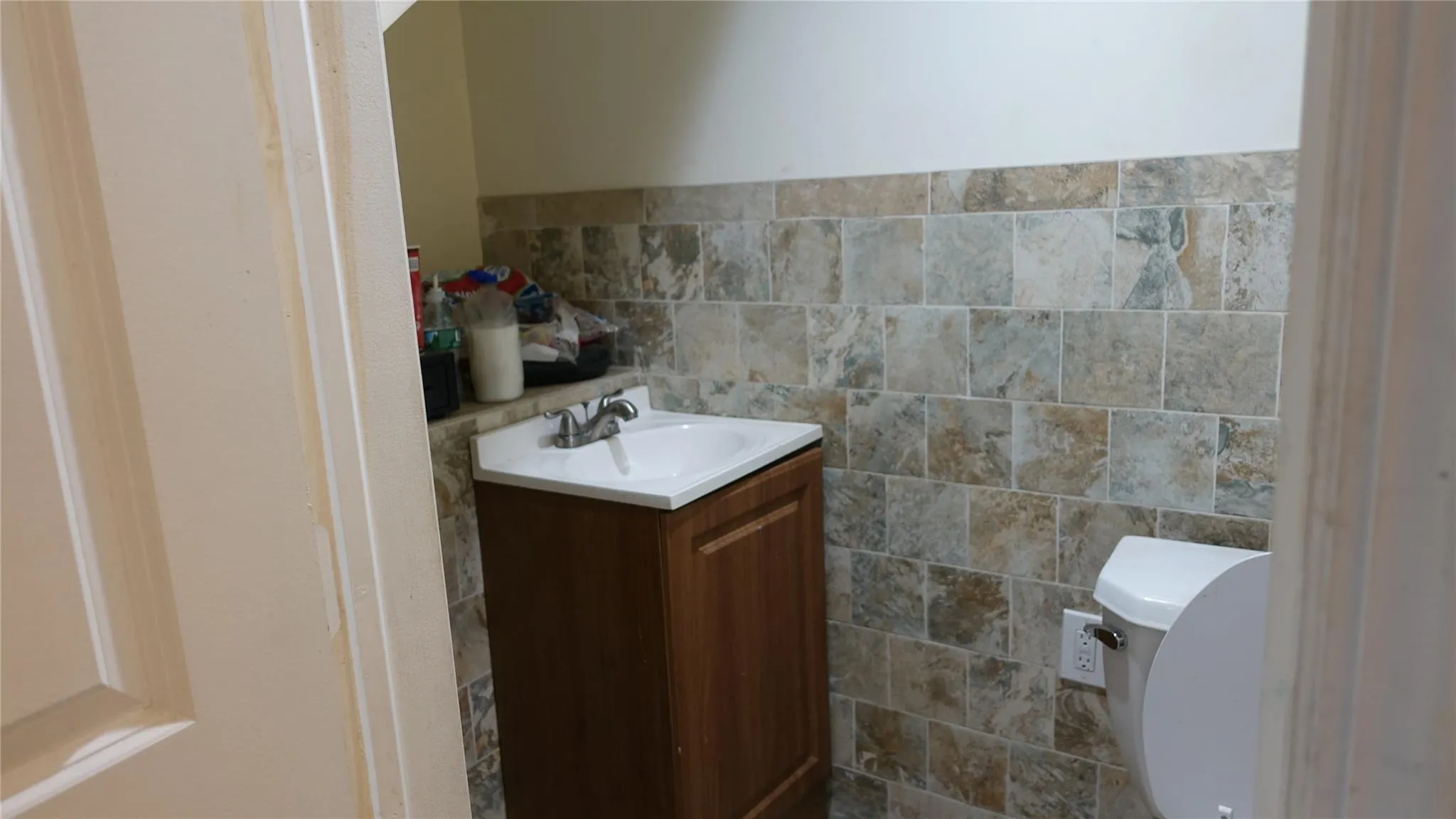 Bathroom with tile walls and vanity Bathroom with tile walls and vanity