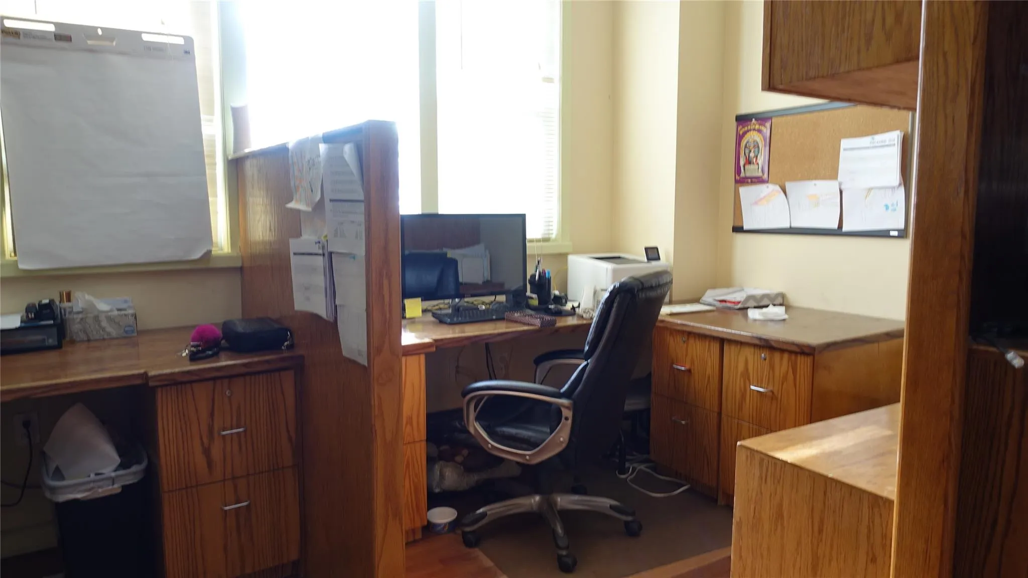 Office area featuring plenty of natural light, built in study area, and wood finished floors Office area featuring plenty of natural light, built in study area, and wood finished floors
