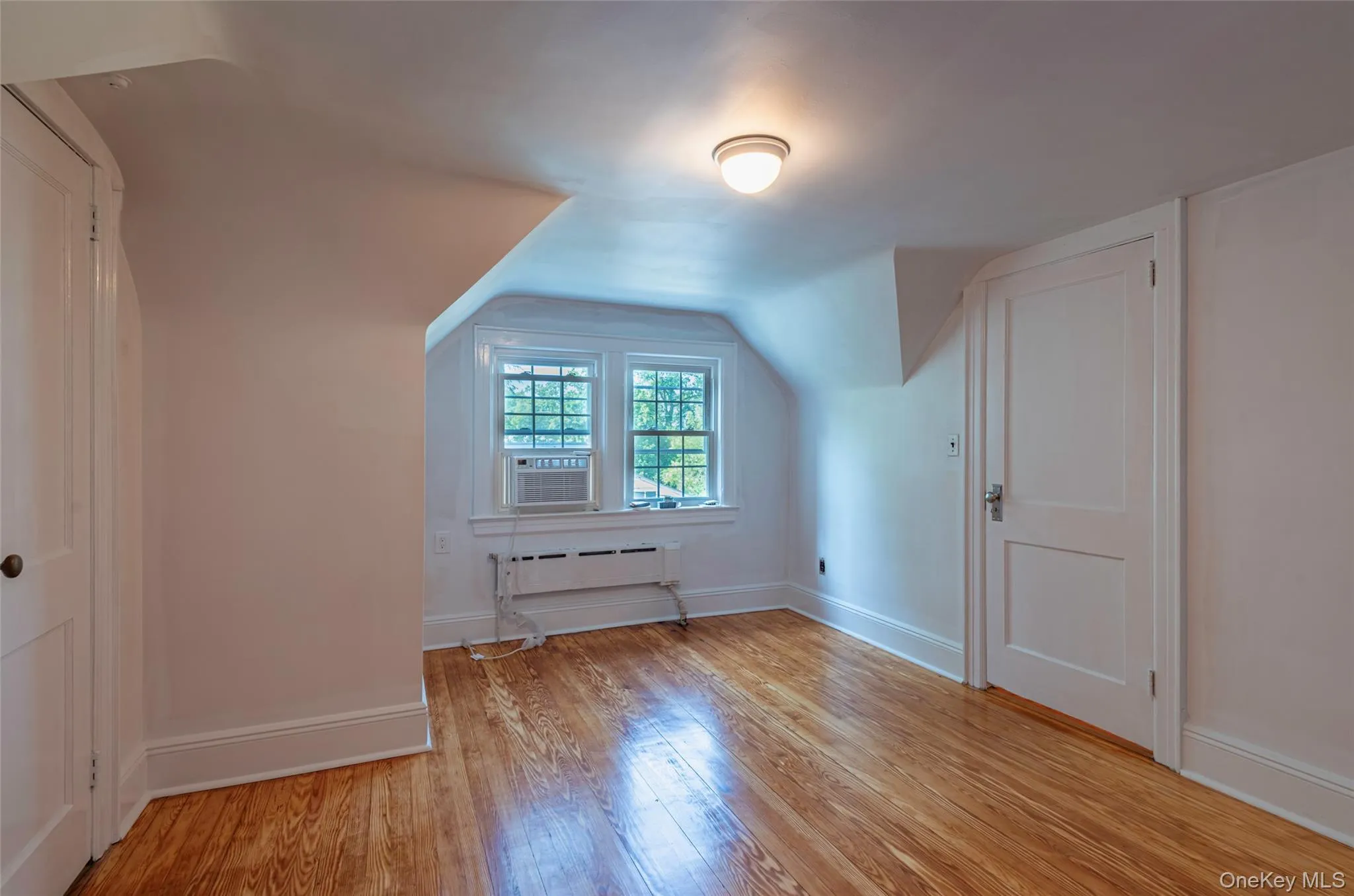 Additional living space featuring light wood-style floors and lofted ceiling Additional living space featuring light wood-style floors and lofted ceiling