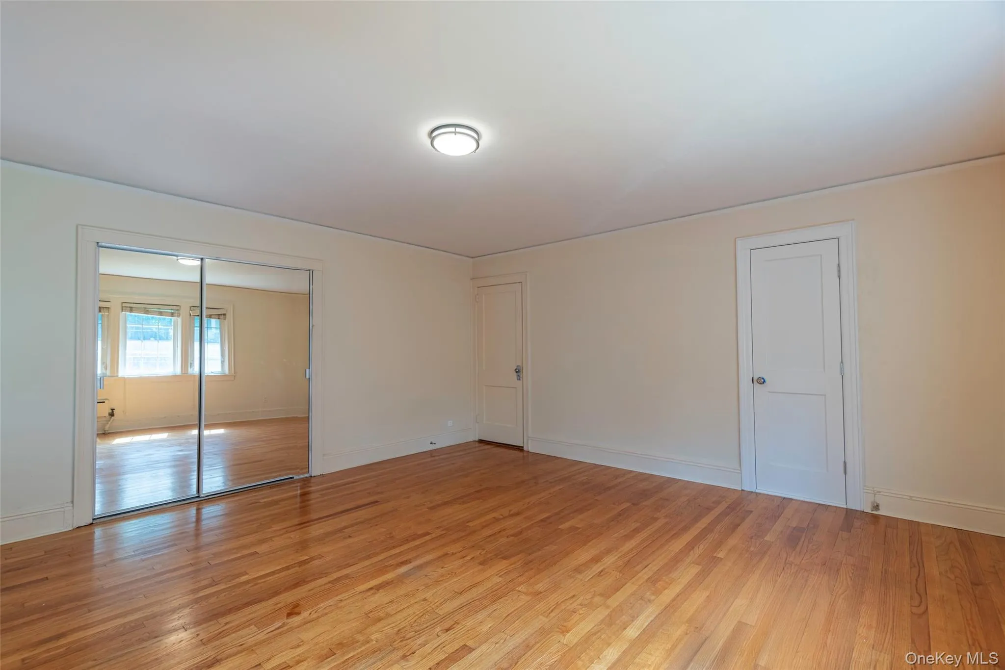 Unfurnished bedroom with light wood-style flooring and a closet Unfurnished bedroom with light wood-style flooring and a closet