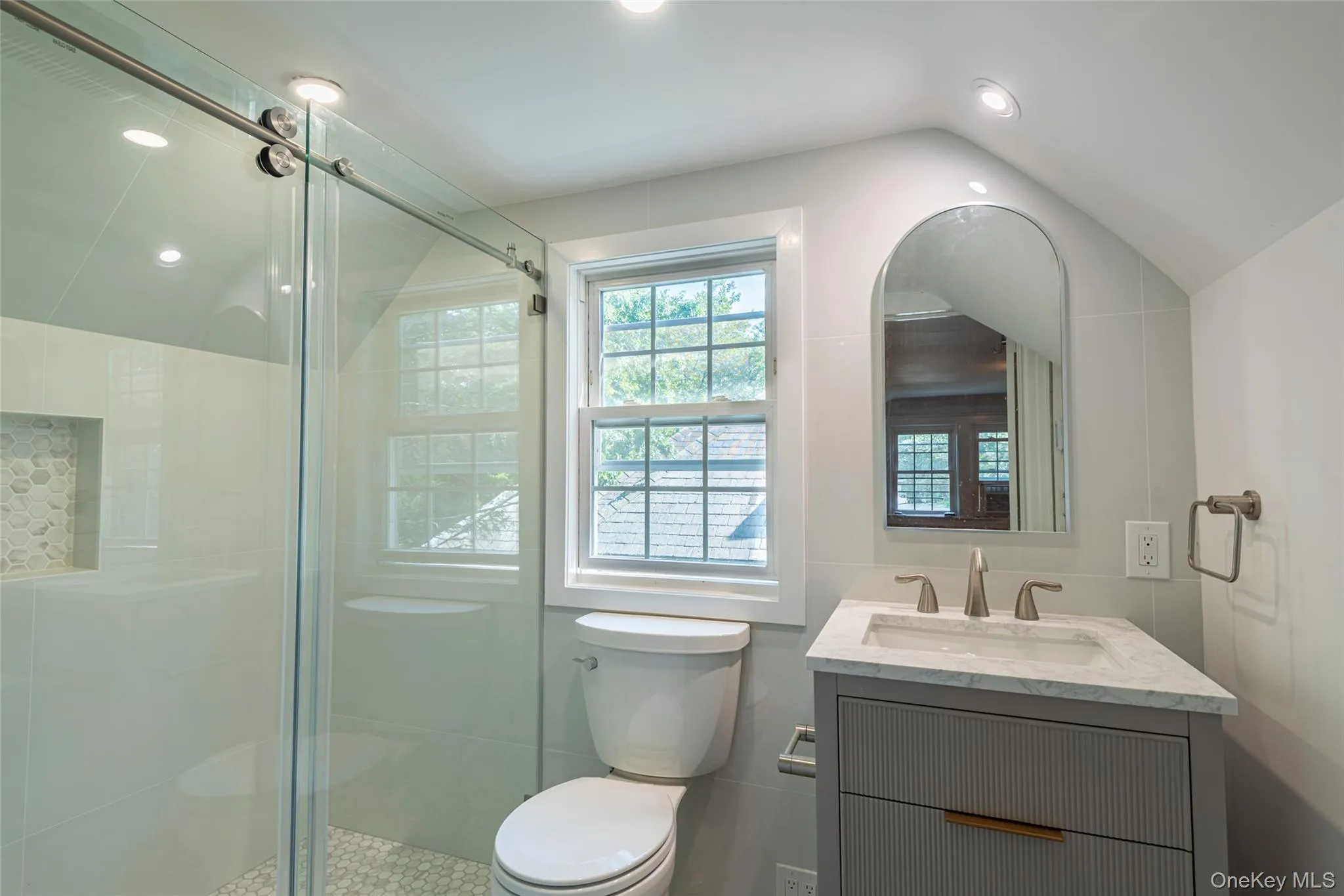 Bathroom with vanity, a stall shower, recessed lighting, and vaulted ceiling Bathroom with vanity, a stall shower, recessed lighting, and vaulted ceiling