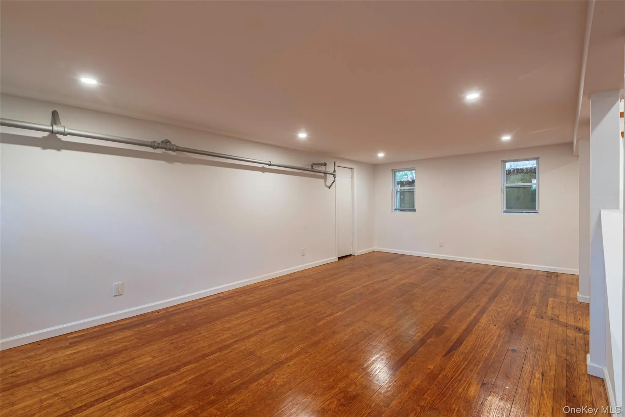 Basement with hardwood / wood-style floors and recessed lighting Basement with hardwood / wood-style floors and recessed lighting