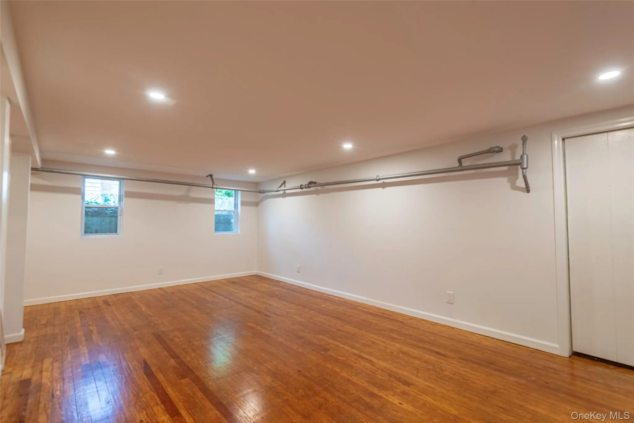 Basement with recessed lighting and light wood-type flooring Basement with recessed lighting and light wood-type flooring