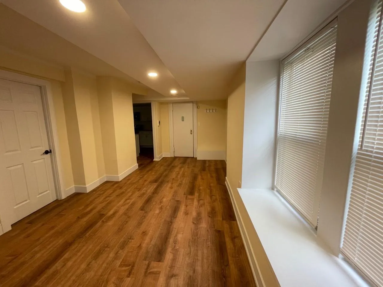 Corridor with wood finished floors and recessed lighting Corridor with wood finished floors and recessed lighting