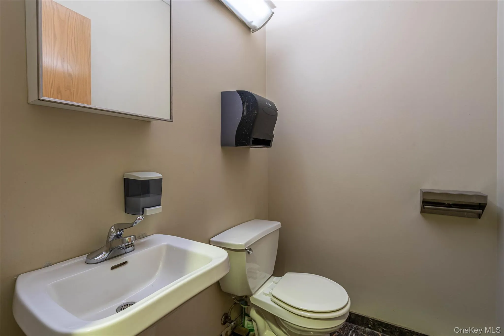 Bathroom featuring a sink and toilet Bathroom featuring a sink and toilet