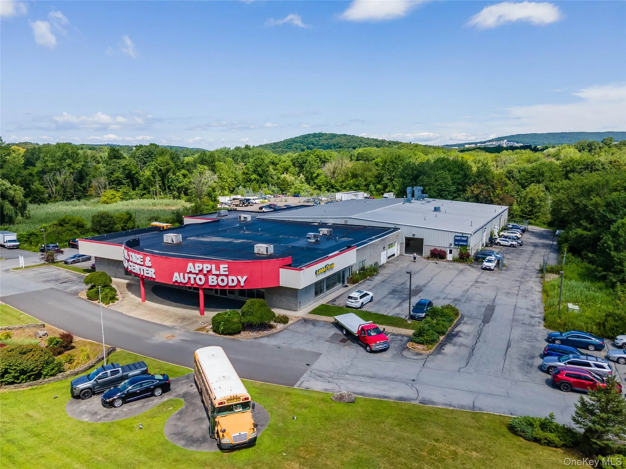 Bird's eye view of a commercial area and a heavily wooded area Bird's eye view of a commercial area and a heavily wooded area