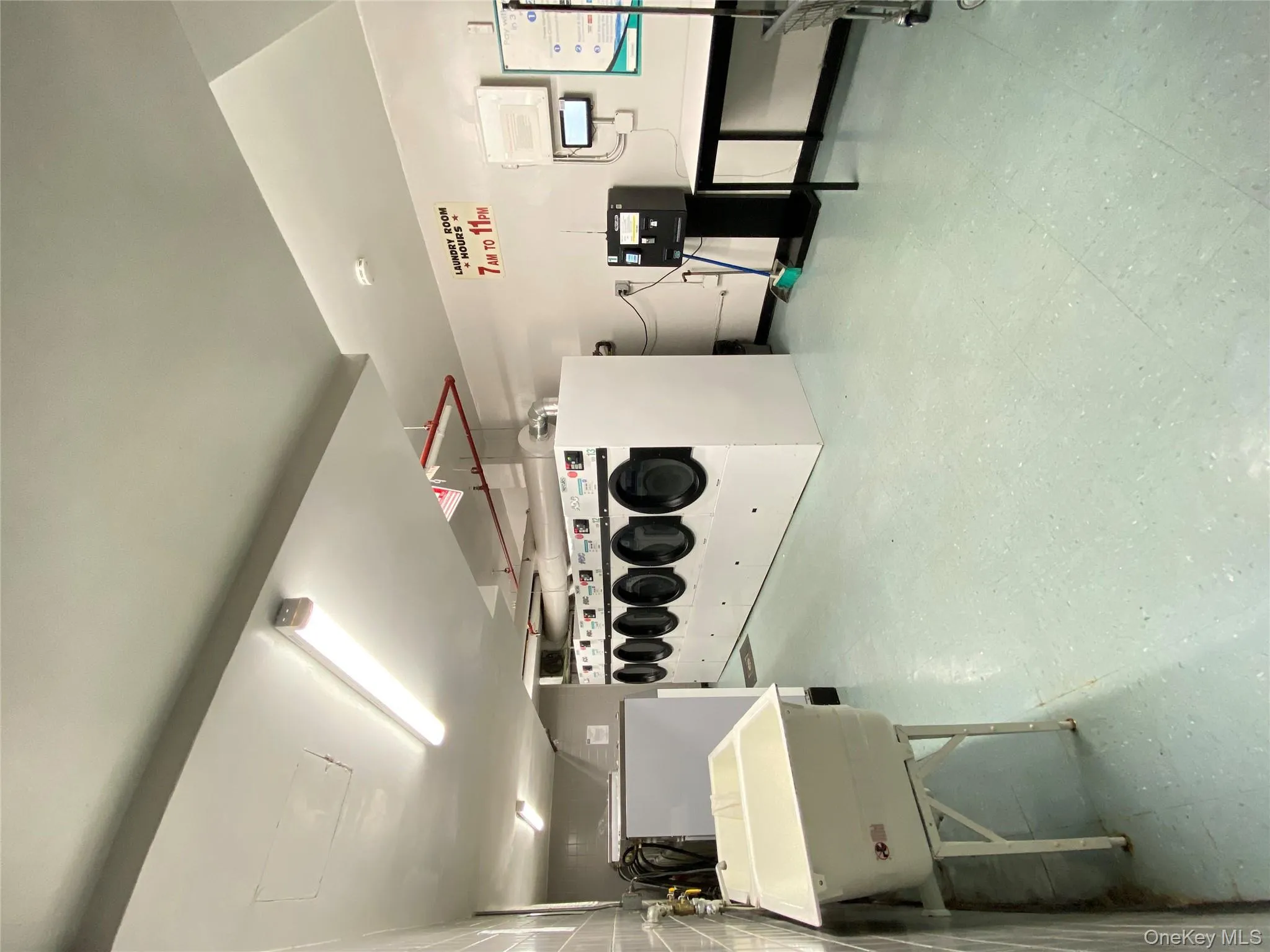 Shared laundry room with light floors and separate washer and dryer Shared laundry room with light floors and separate washer and dryer