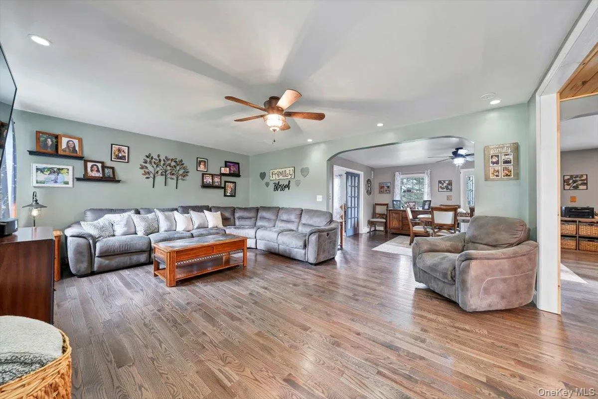 Living area with arched walkways, recessed lighting, wood finished floors, and ceiling fan Living area with arched walkways, recessed lighting, wood finished floors, and ceiling fan