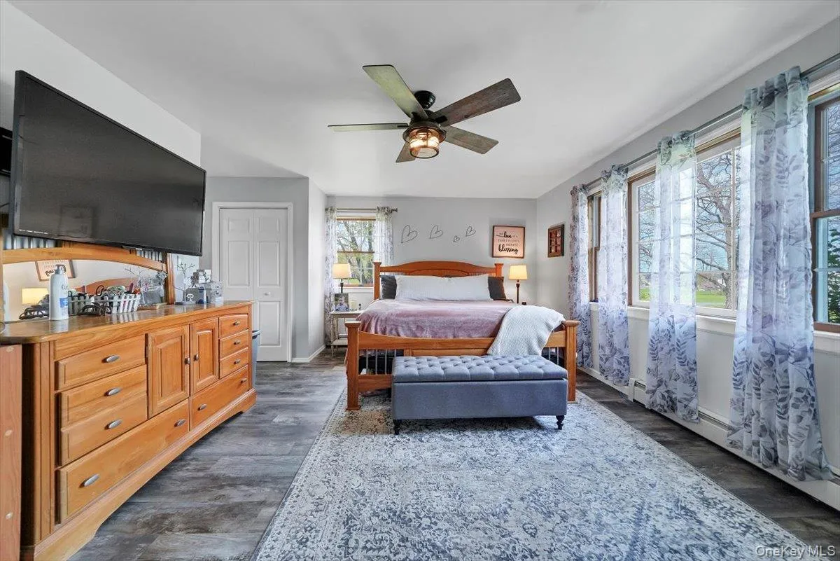 Bedroom featuring dark wood-style flooring and ceiling fan Bedroom featuring dark wood-style flooring and ceiling fan