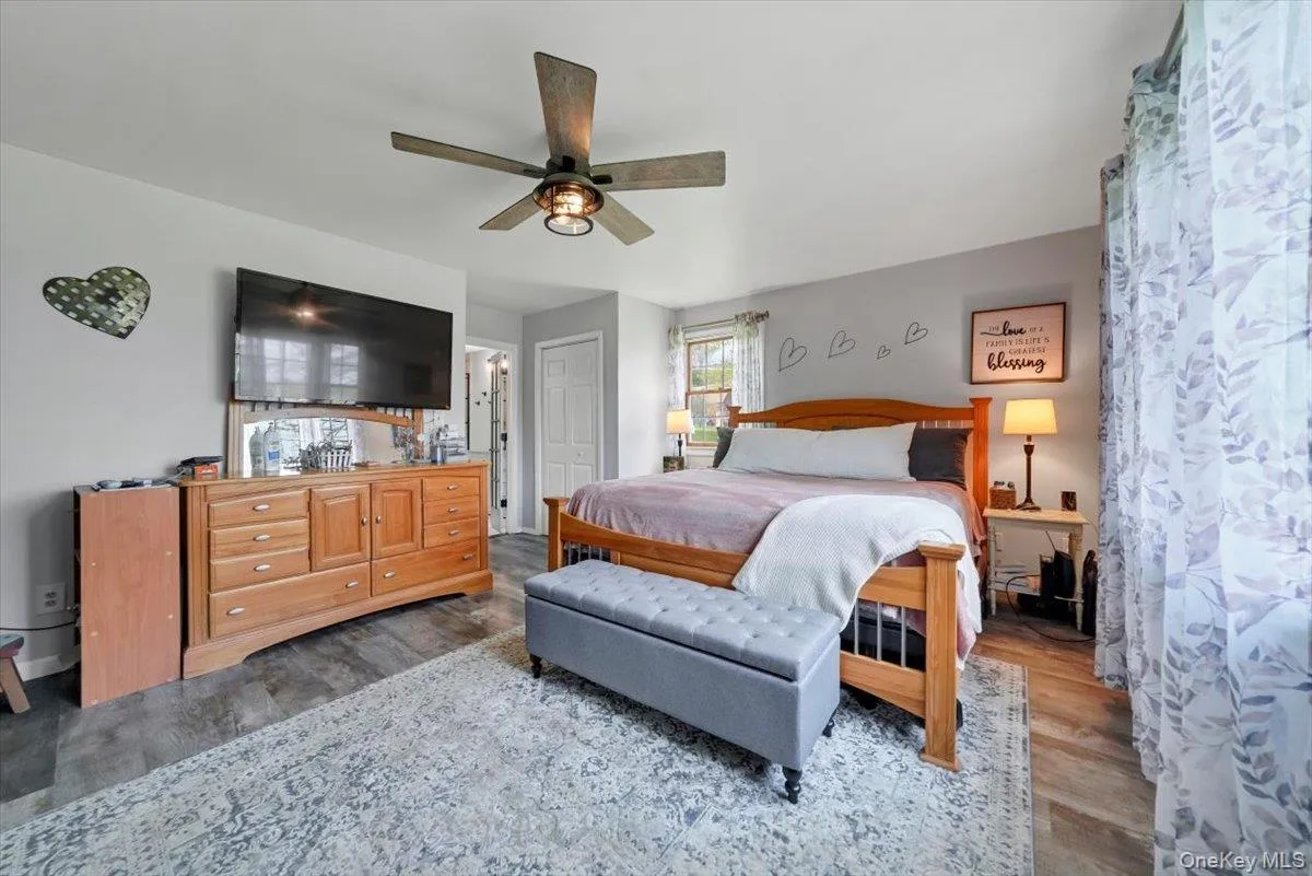 Bedroom featuring wood finished floors and a ceiling fan Bedroom featuring wood finished floors and a ceiling fan