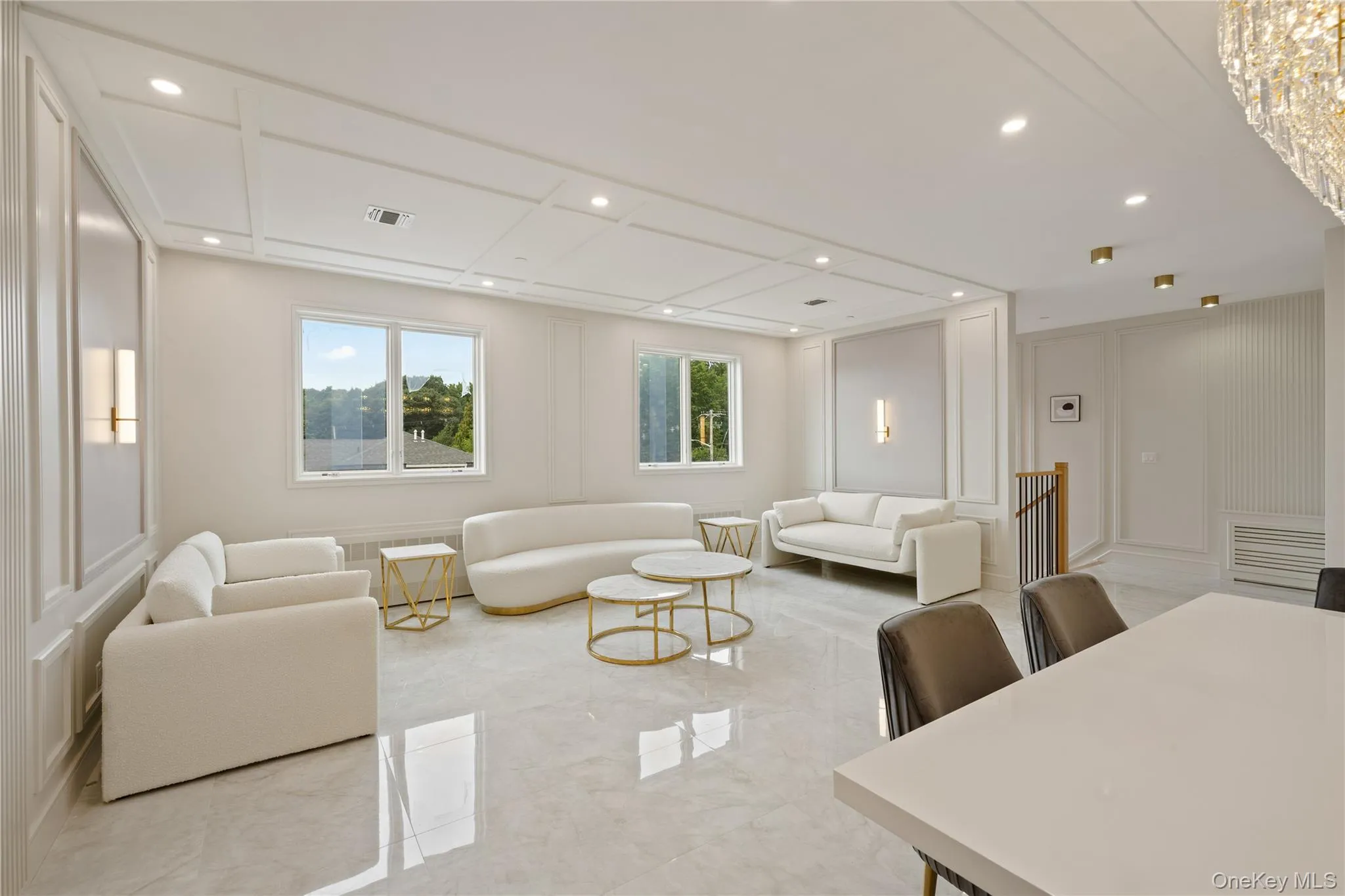 Living room featuring a decorative wall, marble tiled floors, and recessed lighting Living room featuring a decorative wall, marble tiled floors, and recessed lighting