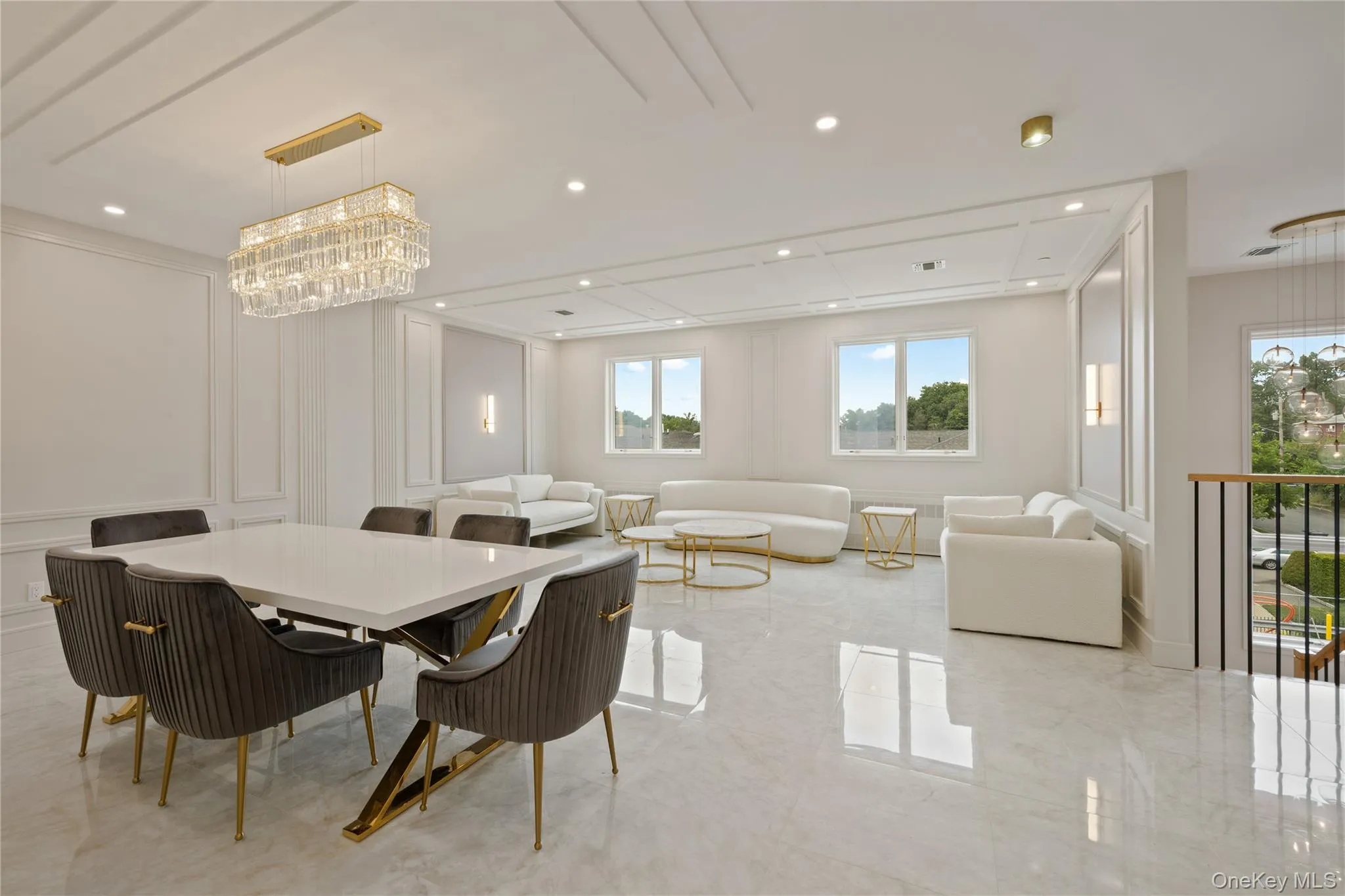 Dining area featuring a decorative wall, a chandelier, recessed lighting, and light marble finish flooring Dining area featuring a decorative wall, a chandelier, recessed lighting, and light marble finish flooring