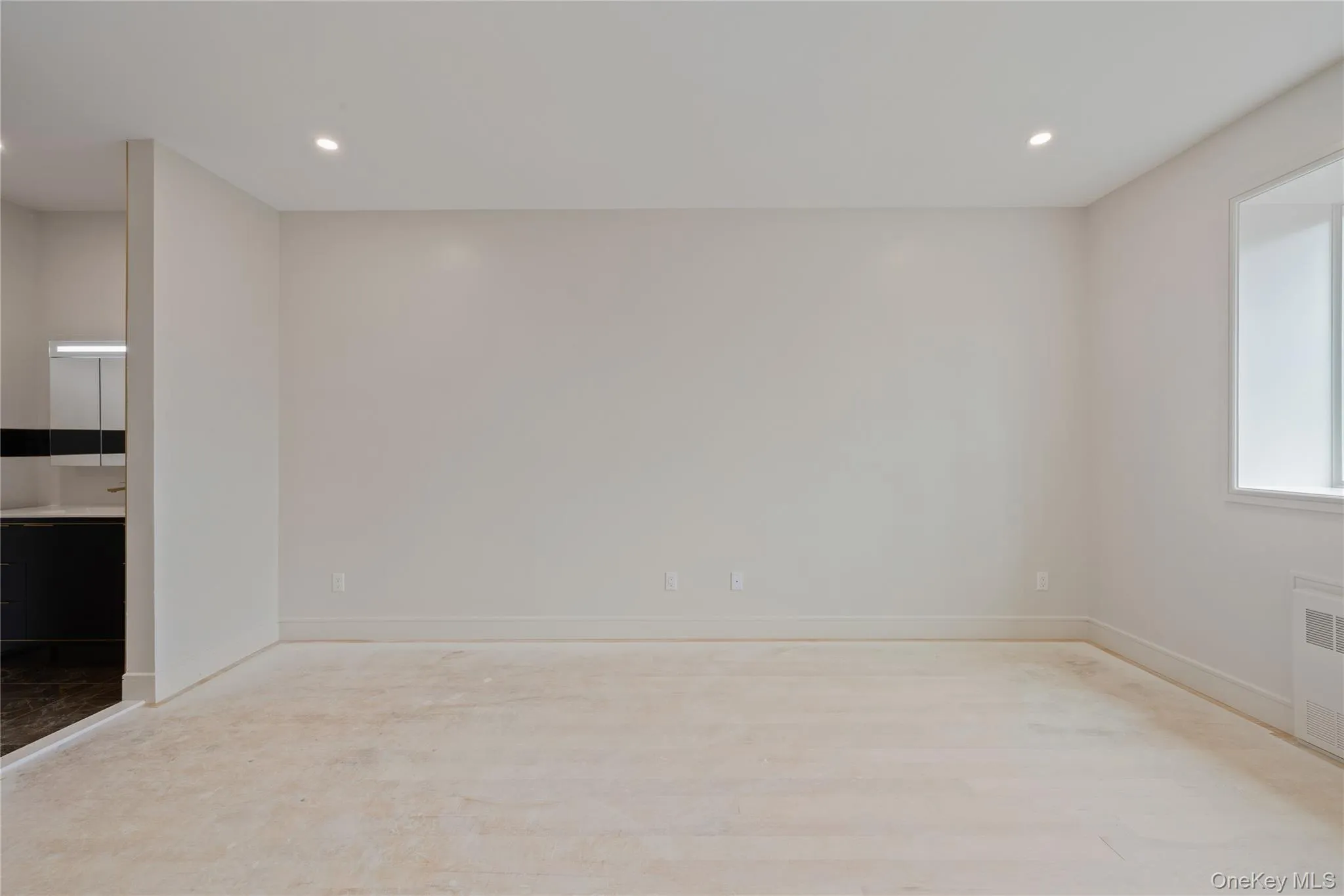 Spare room featuring recessed lighting and radiator heating unit Spare room featuring recessed lighting and radiator heating unit
