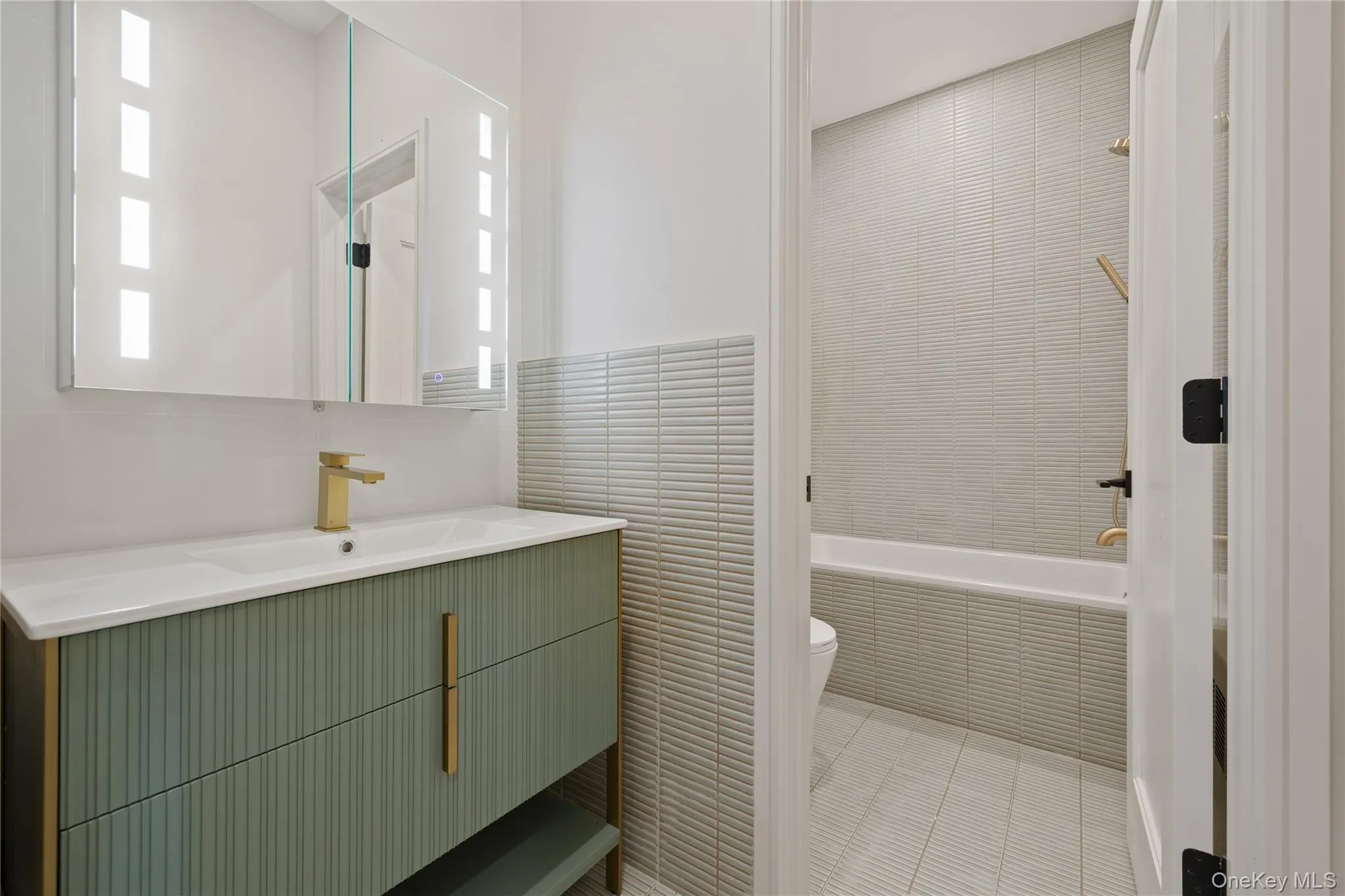 Bathroom featuring vanity and tile walls Bathroom featuring vanity and tile walls