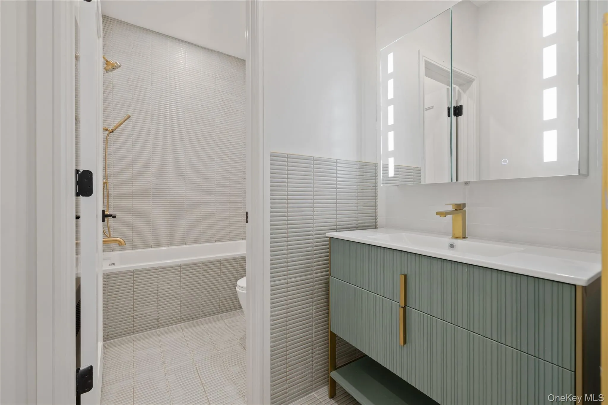 Full bath with vanity, tile walls, and tiled shower / bath Full bath with vanity, tile walls, and tiled shower / bath