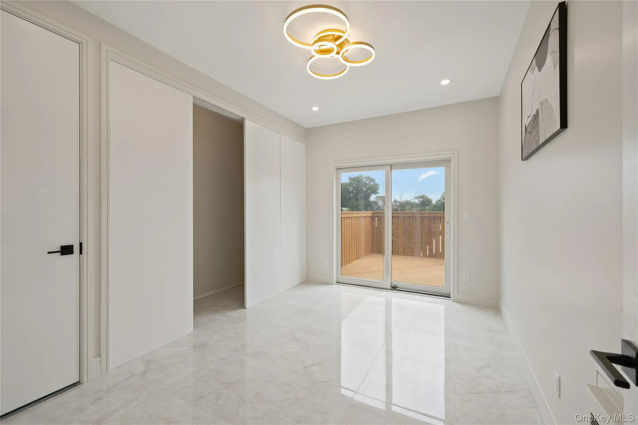 Empty room featuring light marble finish flooring and recessed lighting Empty room featuring light marble finish flooring and recessed lighting