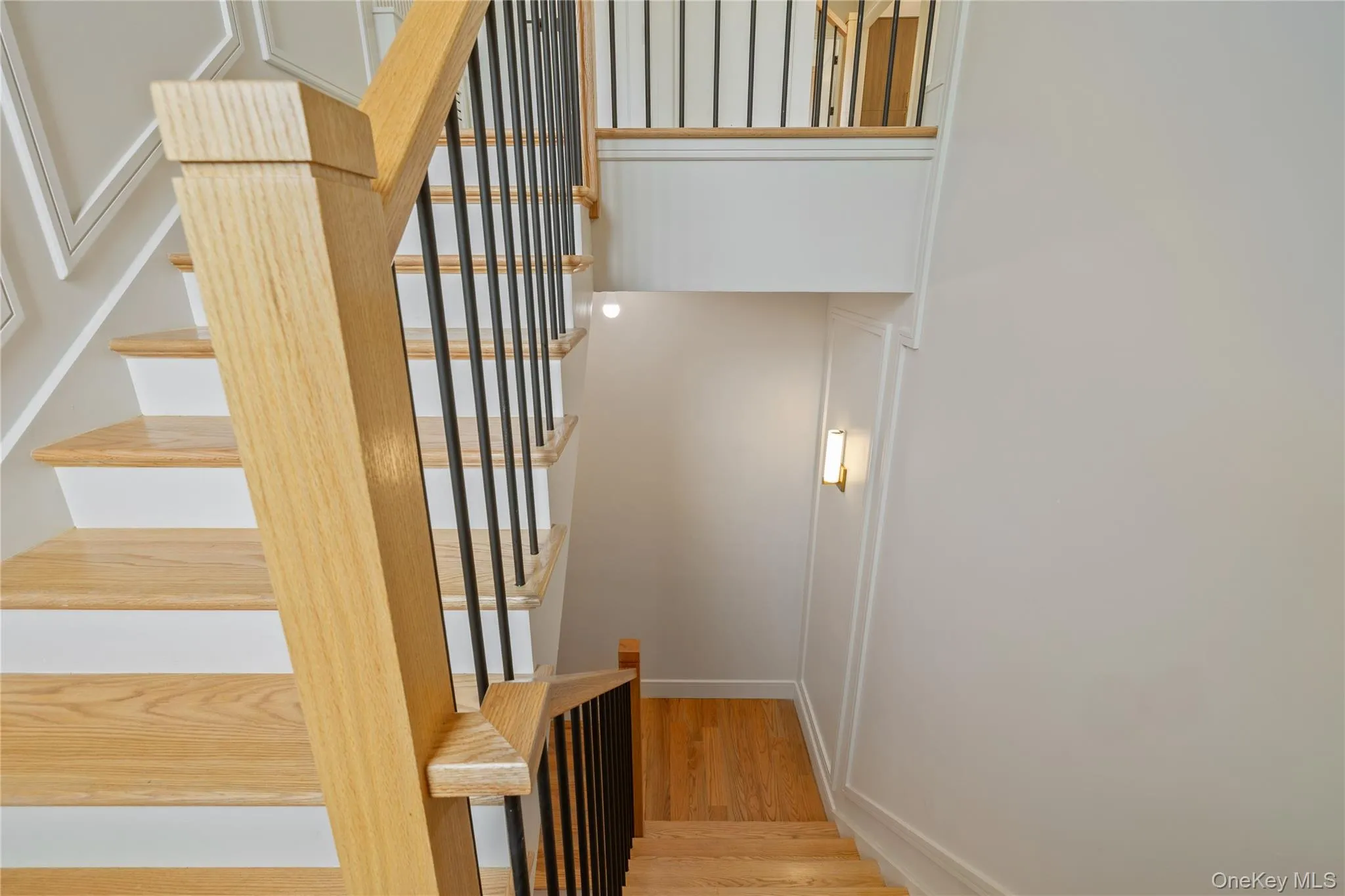 Stairway featuring wood finished floors and baseboards Stairway featuring wood finished floors and baseboards