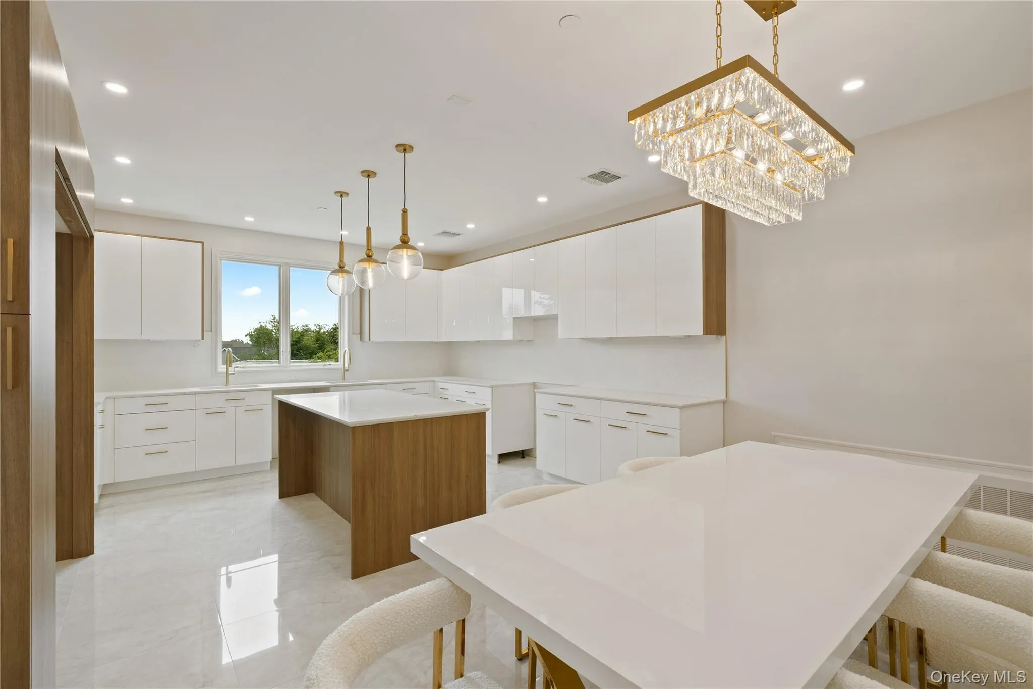 Kitchen with modern cabinets, a kitchen island, recessed lighting, white cabinets, and pendant lighting Kitchen with modern cabinets, a kitchen island, recessed lighting, white cabinets, and pendant lighting