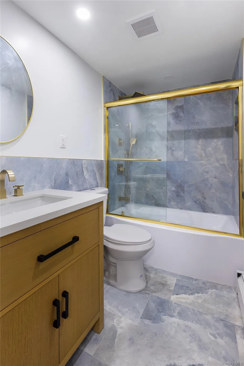 Bathroom featuring vanity and combined bath / shower with glass door Bathroom featuring vanity and combined bath / shower with glass door