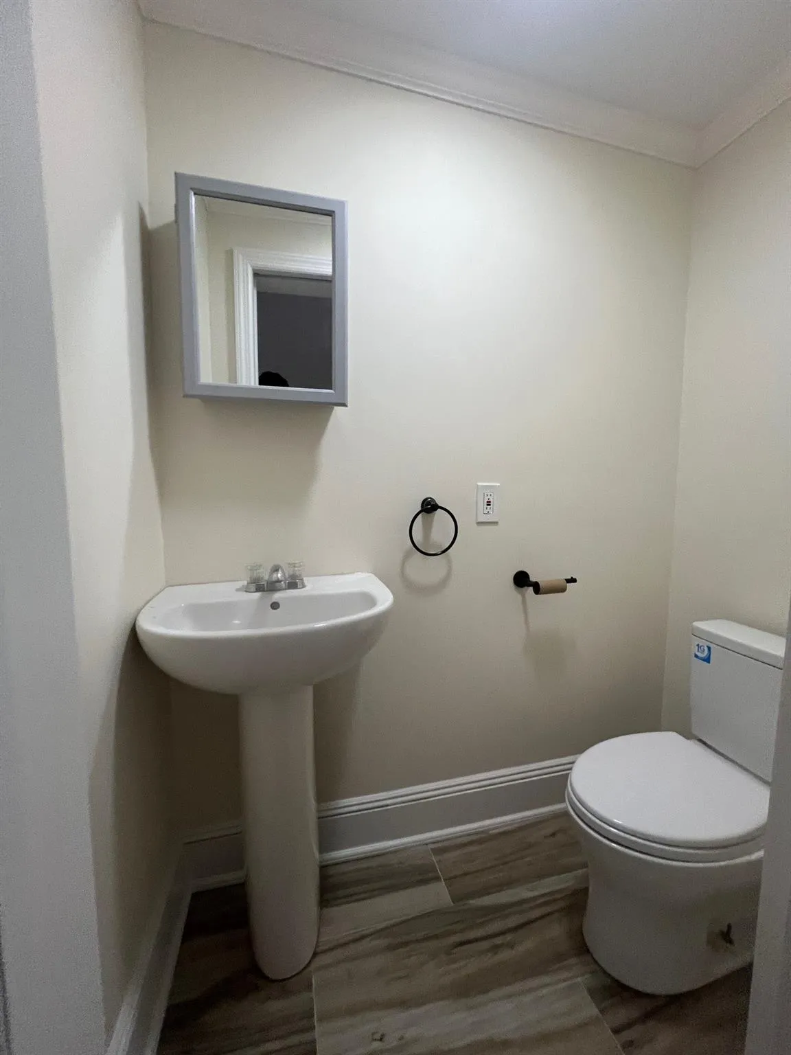 Office 3 Half bathroom with crown molding and wood finished floors Office 3 Half bathroom with crown molding and wood finished floors