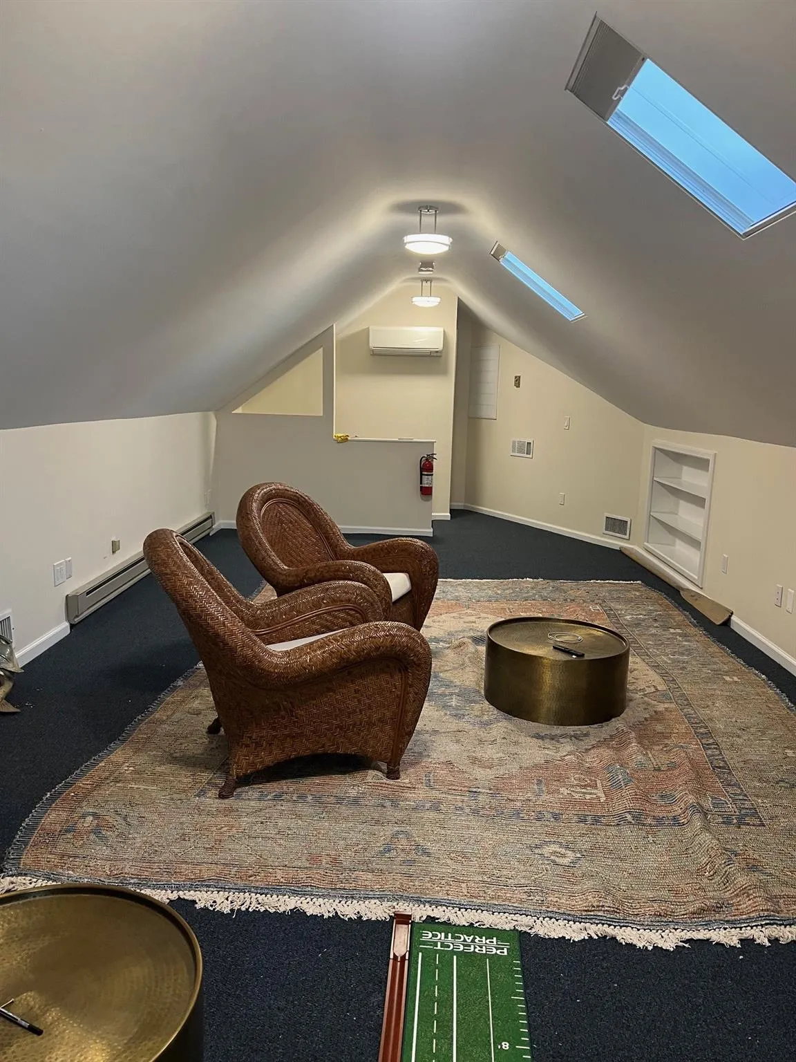 office 2 Sitting room with a skylight, built in features, vaulted ceiling, carpet flooring, and a baseboard heating unit office 2 Sitting room with a skylight, built in features, vaulted ceiling, carpet flooring, and a baseboard heating unit