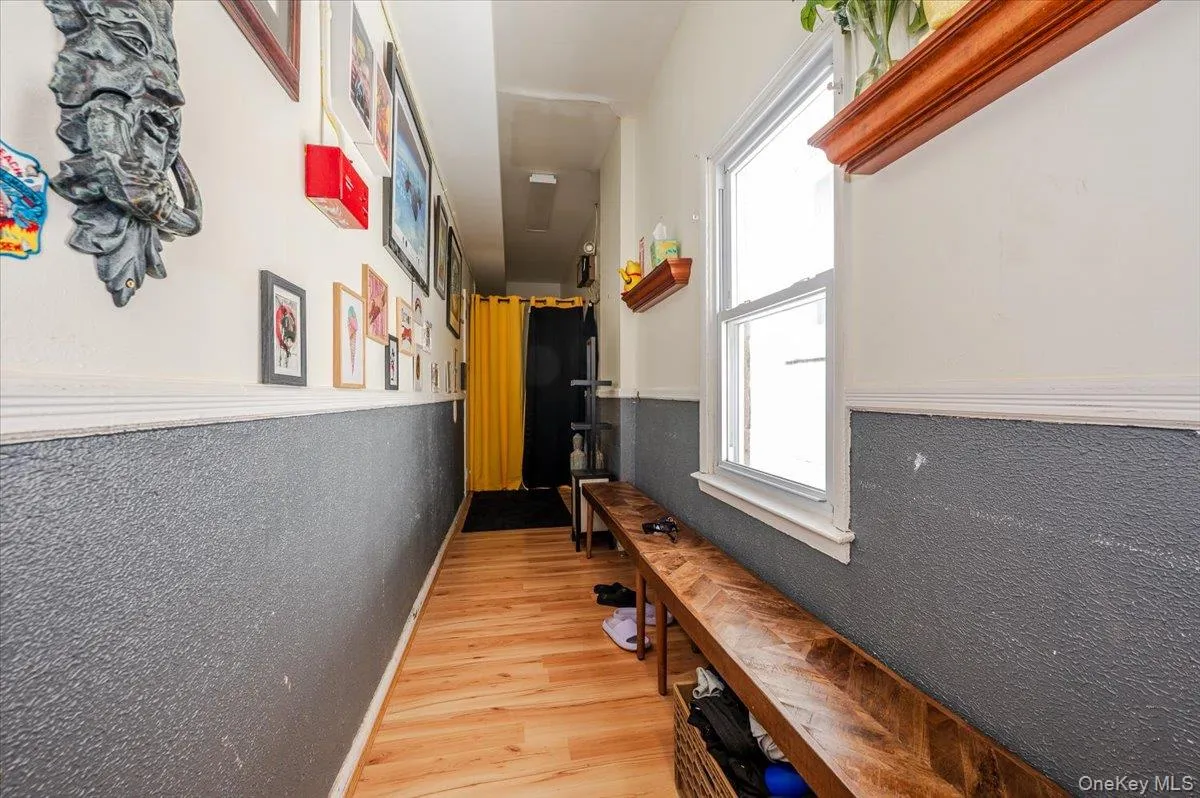 Hallway with wood finished floors and wainscoting Hallway with wood finished floors and wainscoting