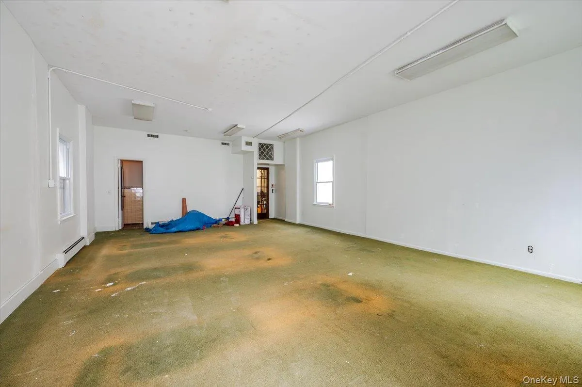 Garage featuring baseboards and a baseboard radiator Garage featuring baseboards and a baseboard radiator