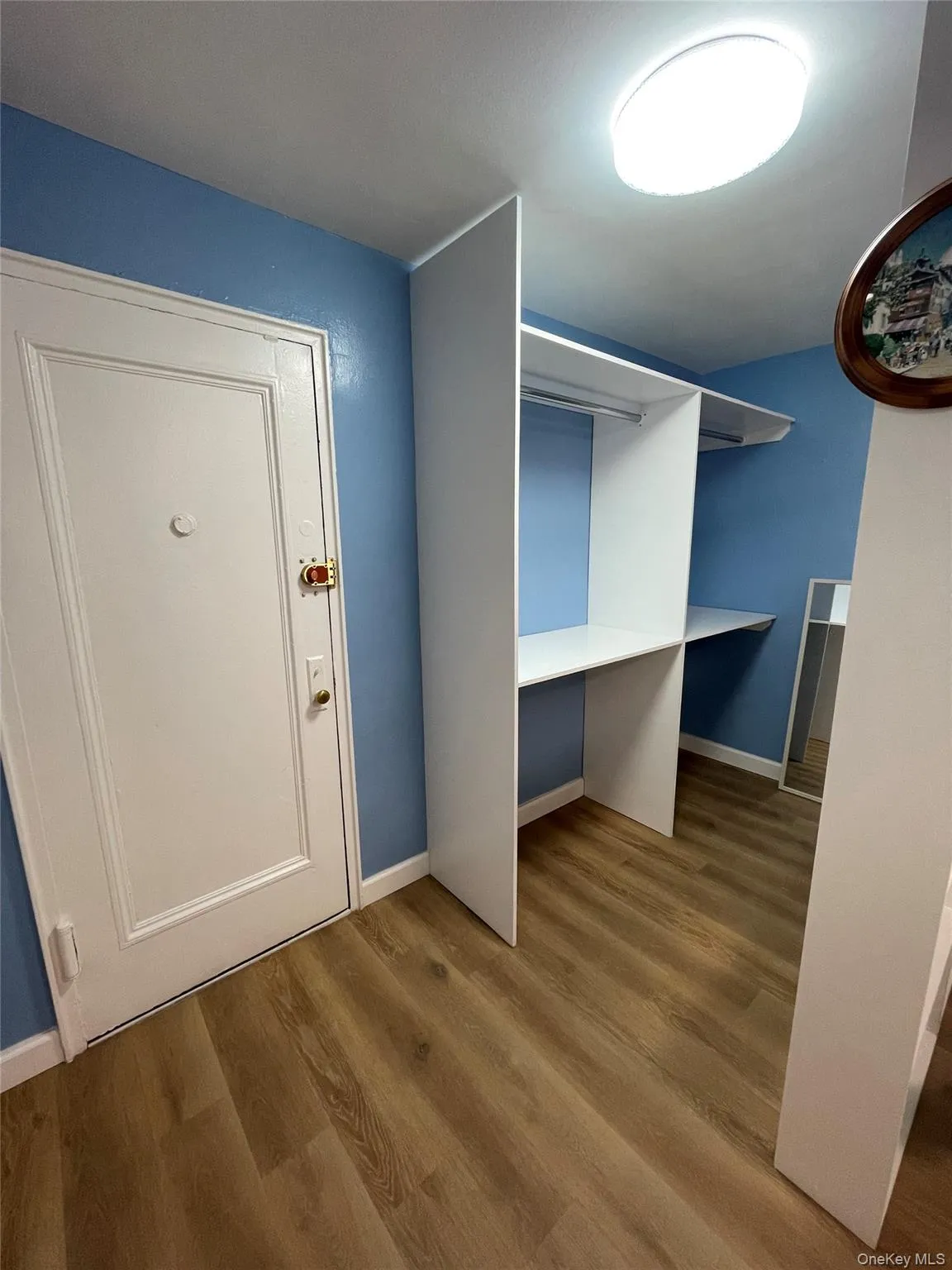 Walk in closet featuring wood finished floors Walk in closet featuring wood finished floors