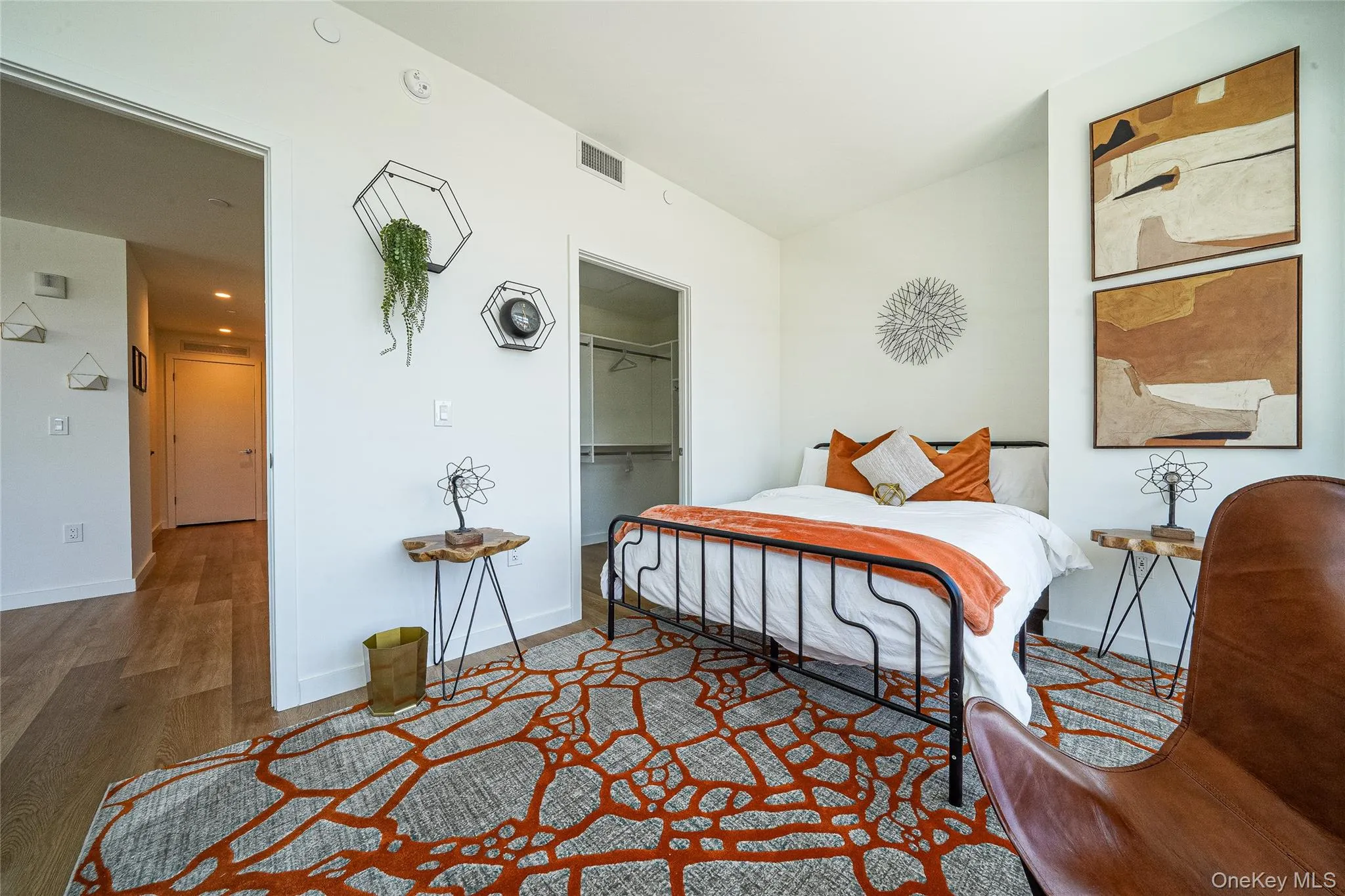 Bedroom with wood finished floors and a spacious closet Bedroom with wood finished floors and a spacious closet