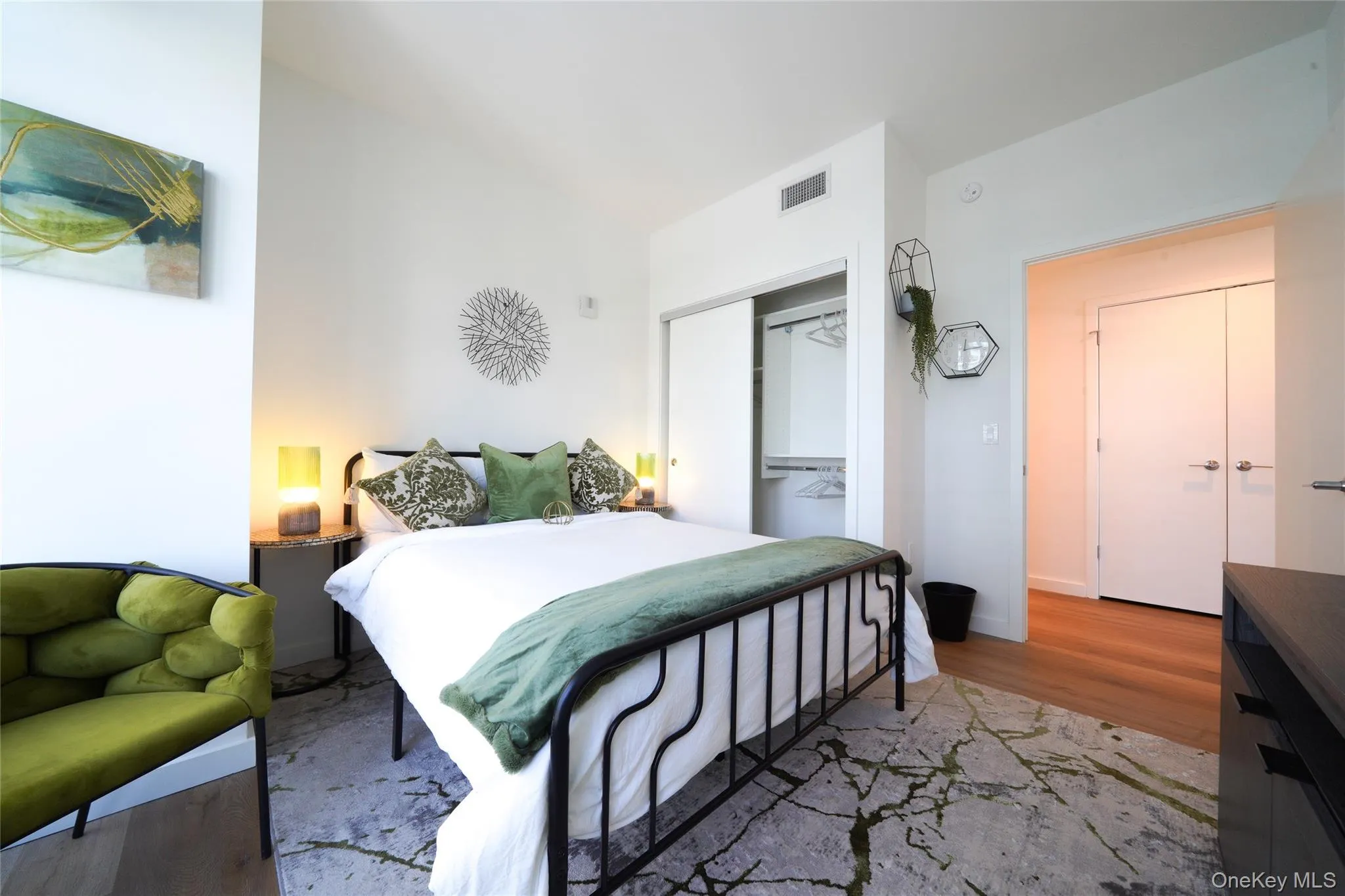 Bedroom featuring light wood-style floors and a closet Bedroom featuring light wood-style floors and a closet