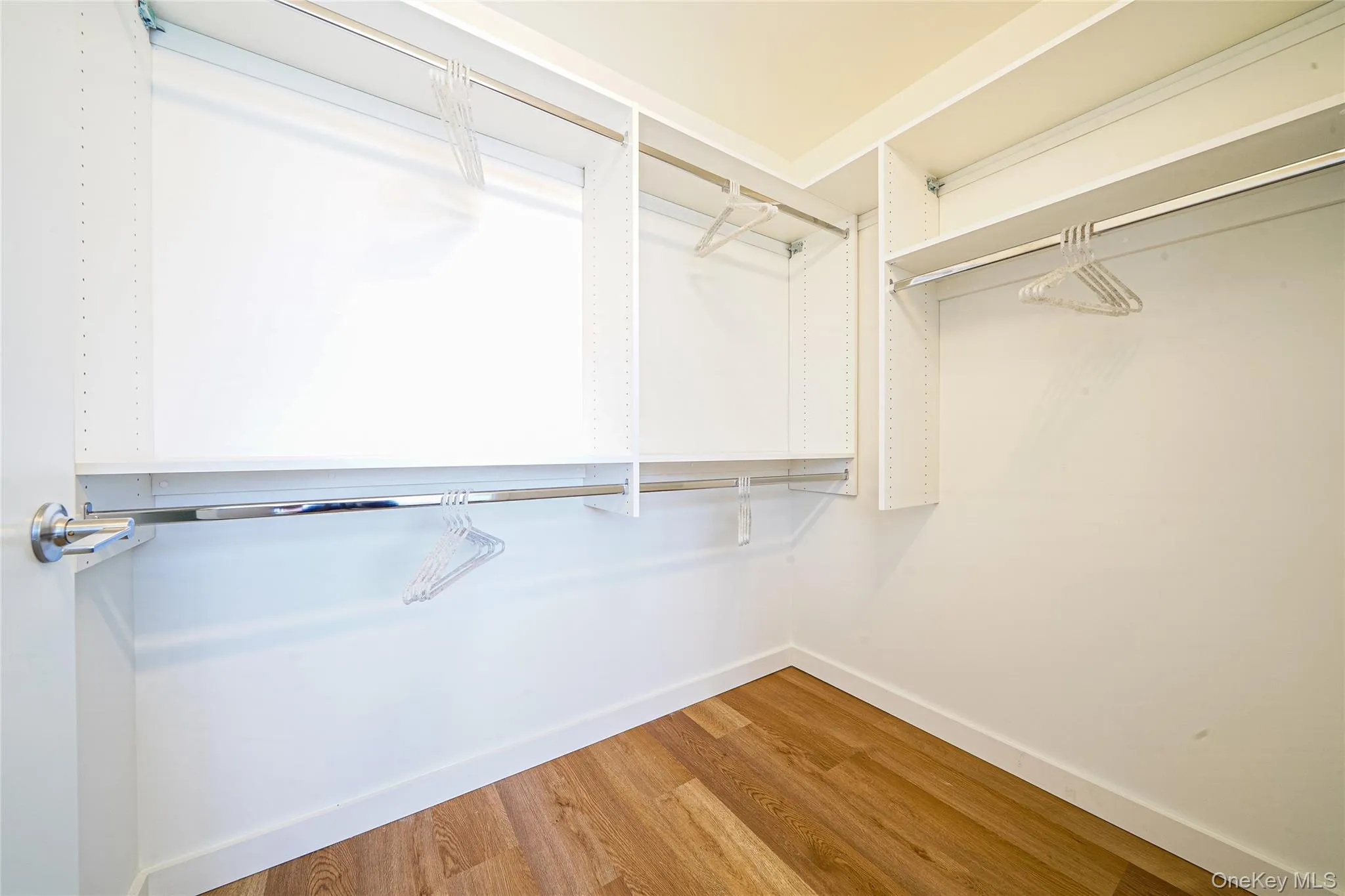 Walk in closet with wood finished floors Walk in closet with wood finished floors