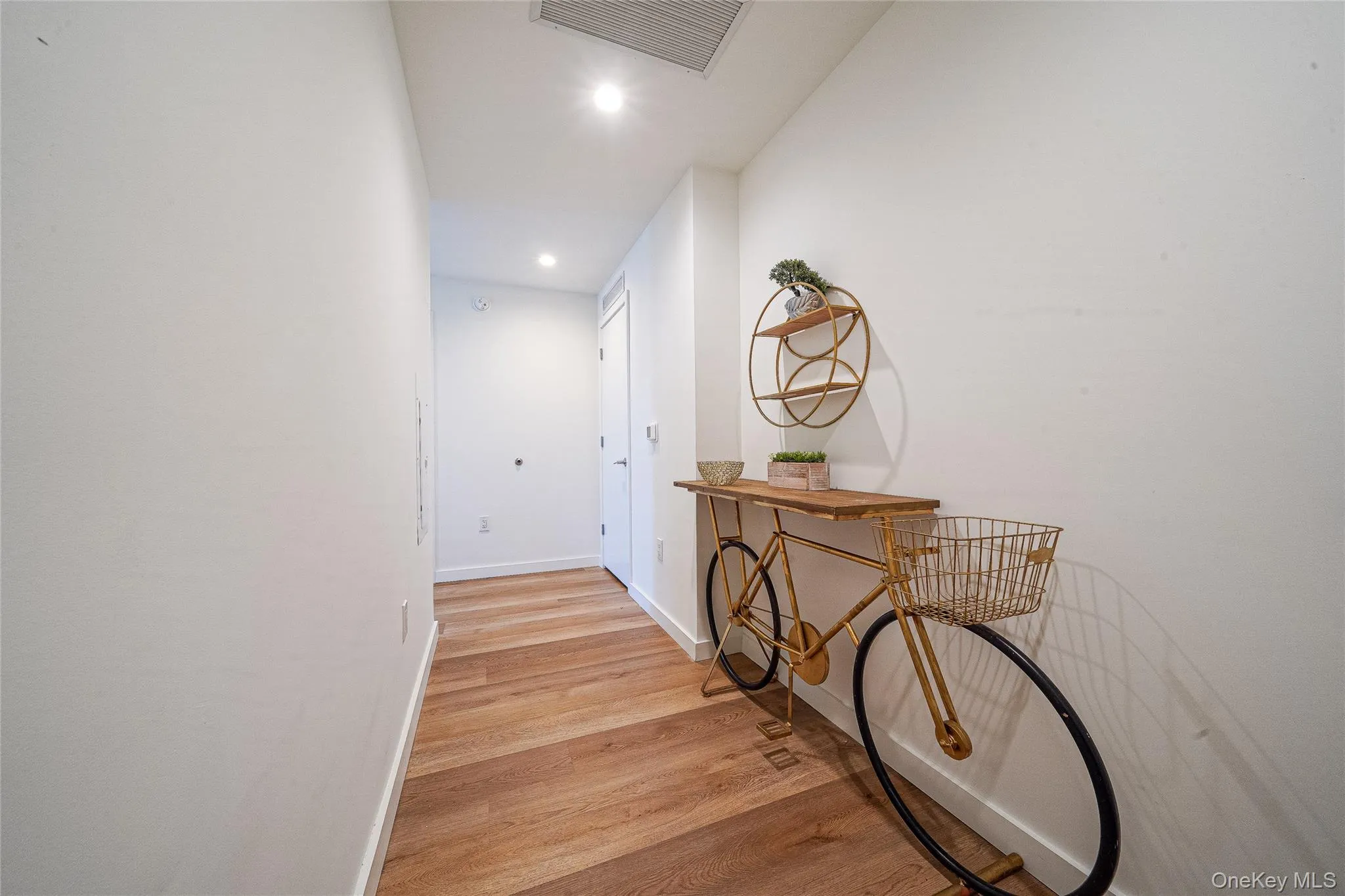 Hallway featuring light wood-style floors and recessed lighting Hallway featuring light wood-style floors and recessed lighting