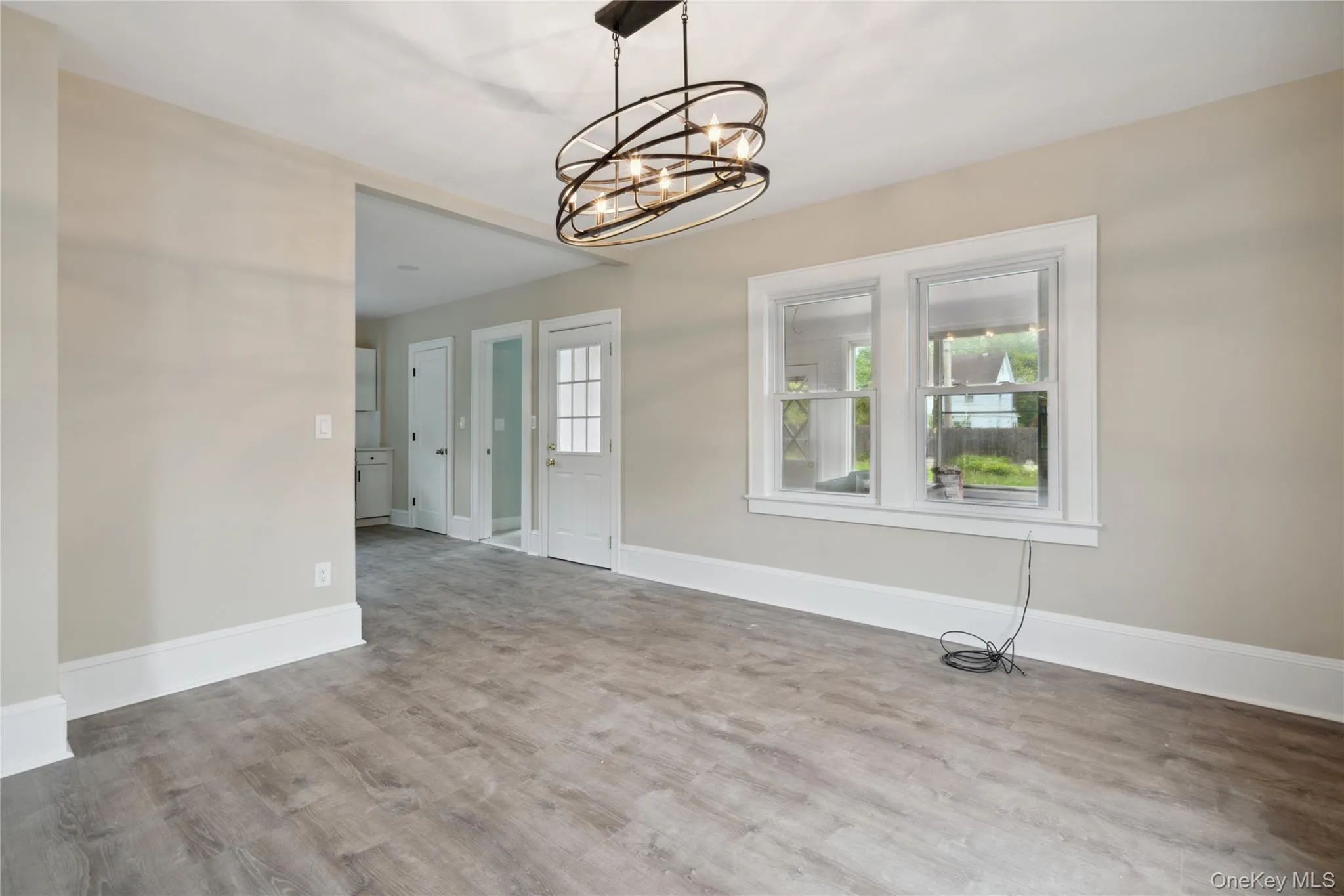Unfurnished dining area with wood finished floors and a chandelier Unfurnished dining area with wood finished floors and a chandelier