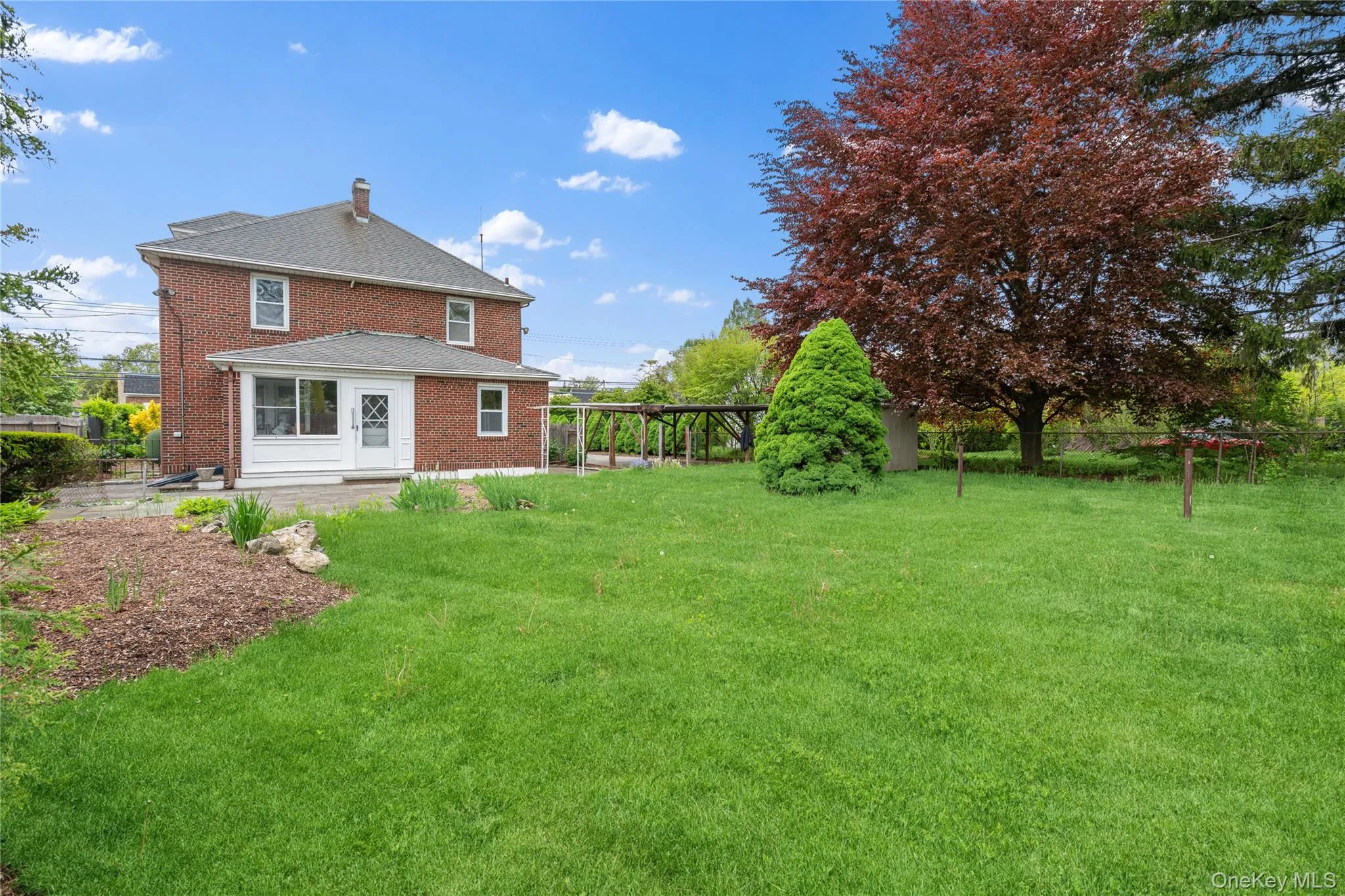 Rear view of property with brick siding, a patio area, and a chimney Rear view of property with brick siding, a patio area, and a chimney