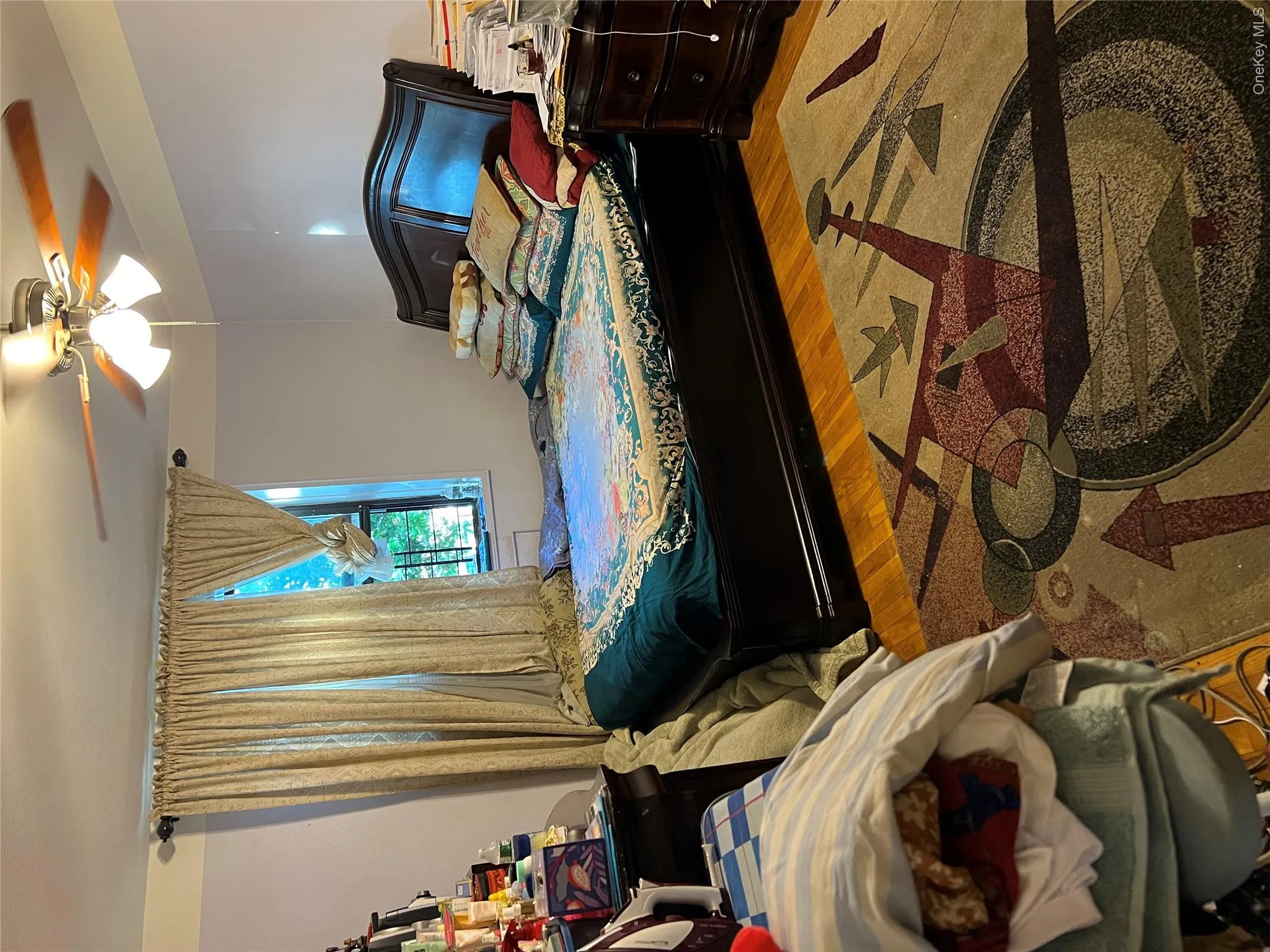 Bedroom featuring wood finished floors and ceiling fan Bedroom featuring wood finished floors and ceiling fan