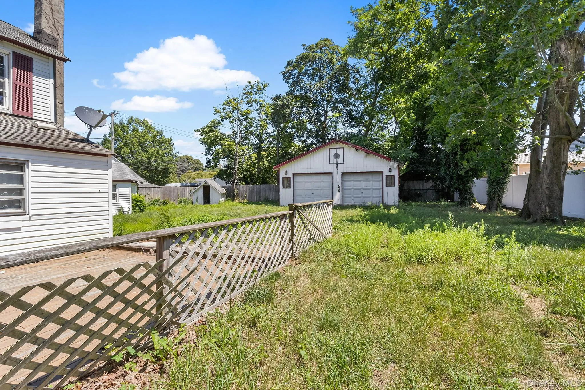 View of yard featuring a detached garage and an outdoor structure View of yard featuring a detached garage and an outdoor structure